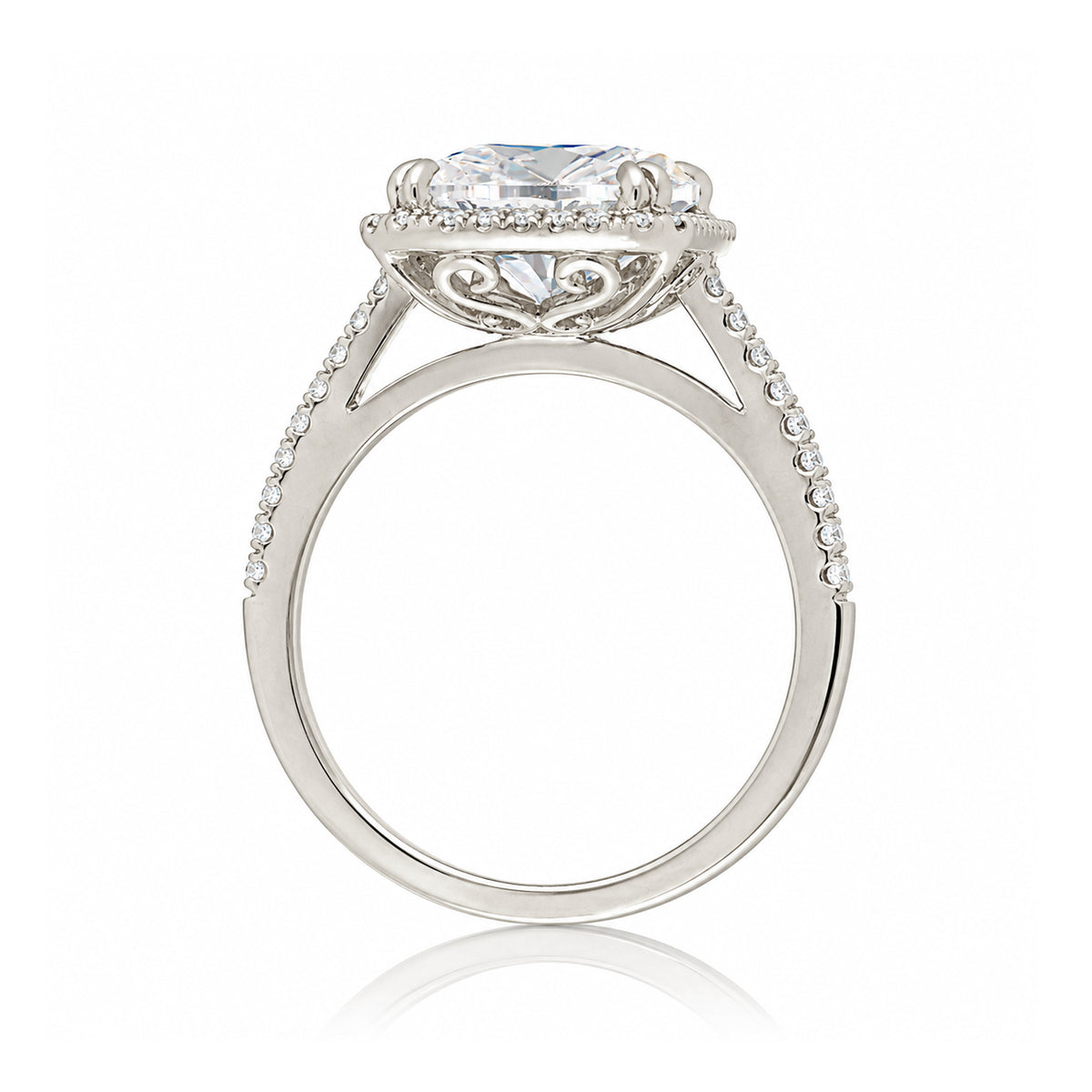 Cushion cut moissanite engagement ring with a diamond halo on the Signature elongated white gold setting