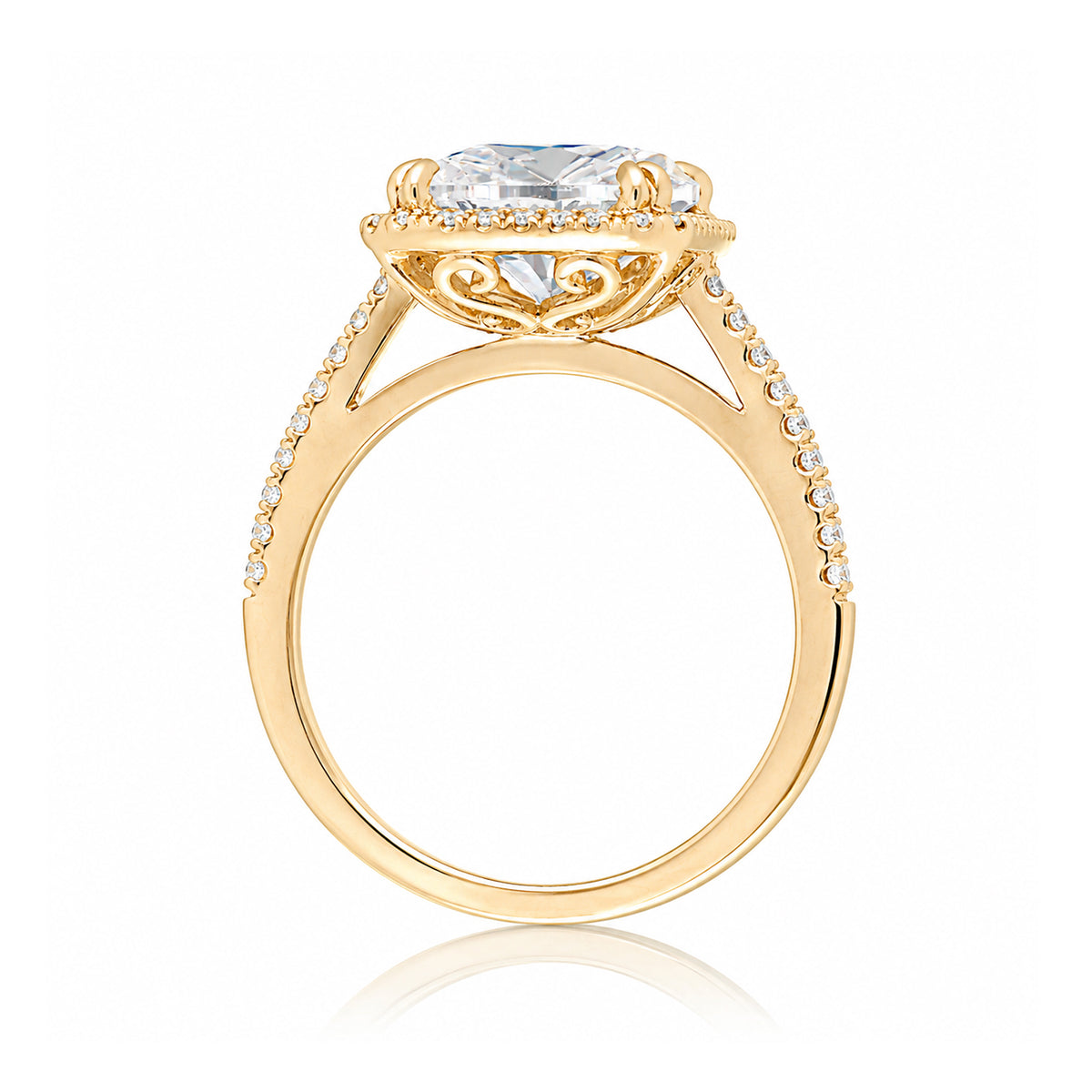 Cushion cut moissanite engagement ring with a diamond halo on the Signature elongated yellow gold setting