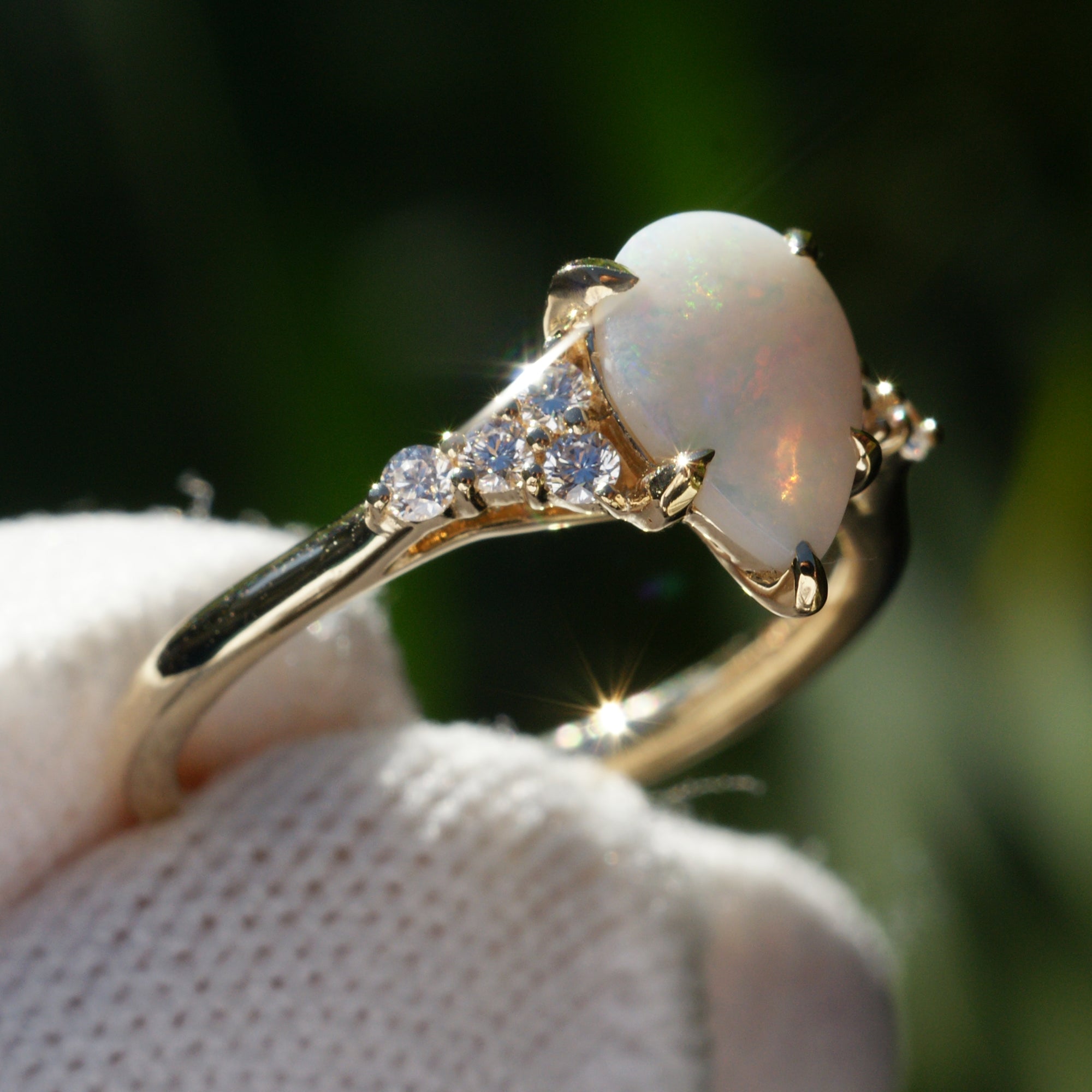 Fiery tear drop opal and diamond three stone ring yellow gold 9x6mm
