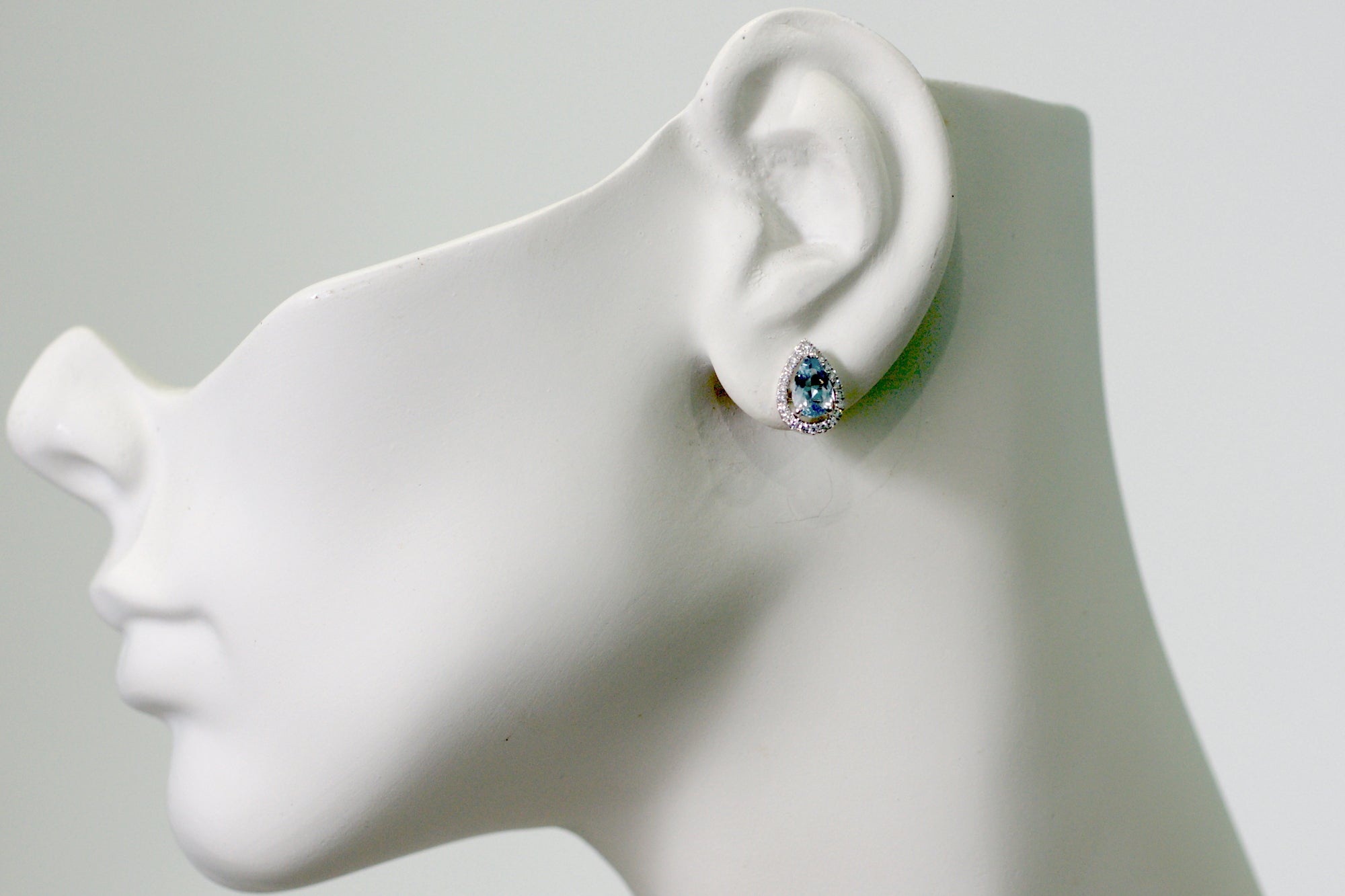 Pear cut aquamarine teardrop and diamond halo stud earrings in white gold