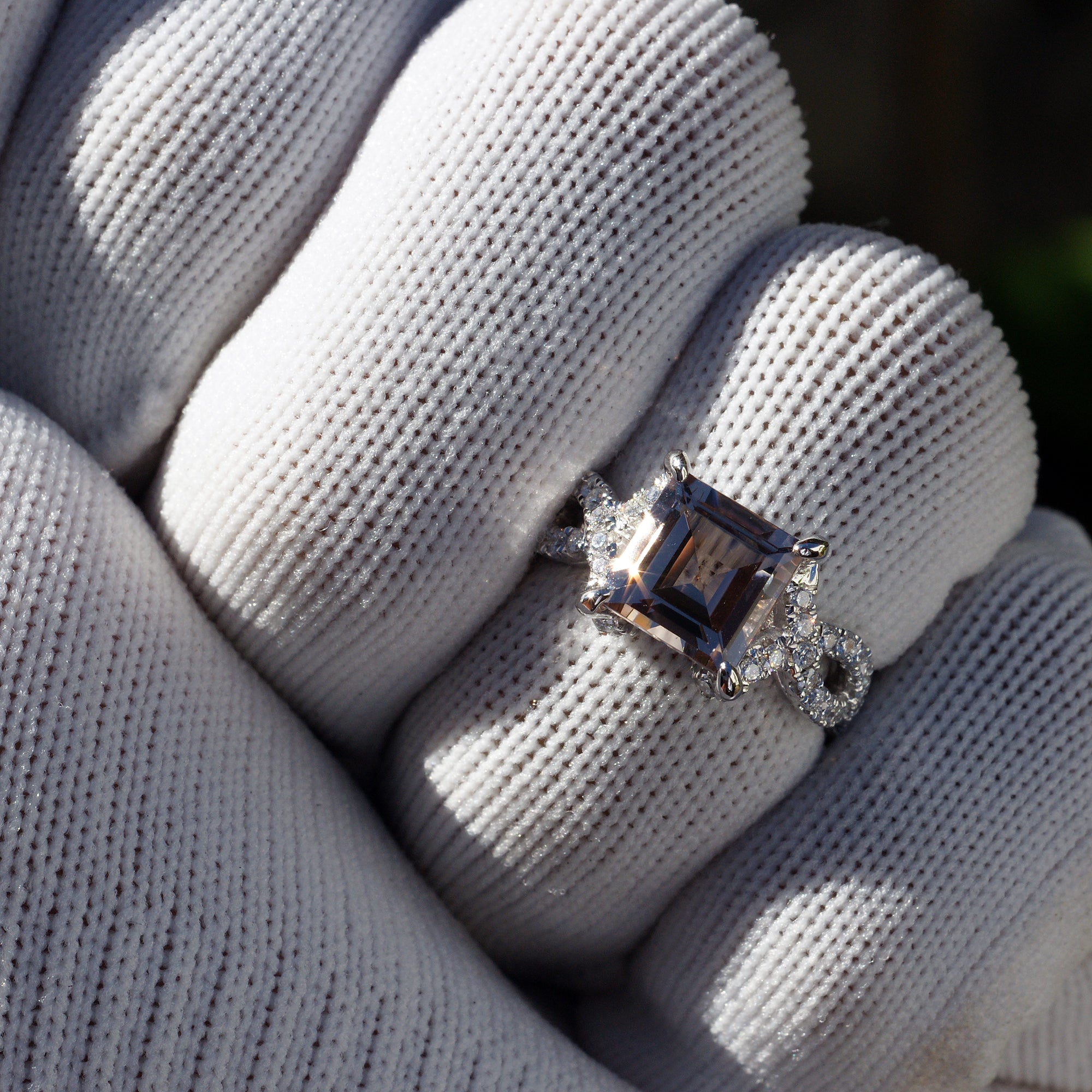 Square morganite engagement ring with diamond accent in white gold on a hand