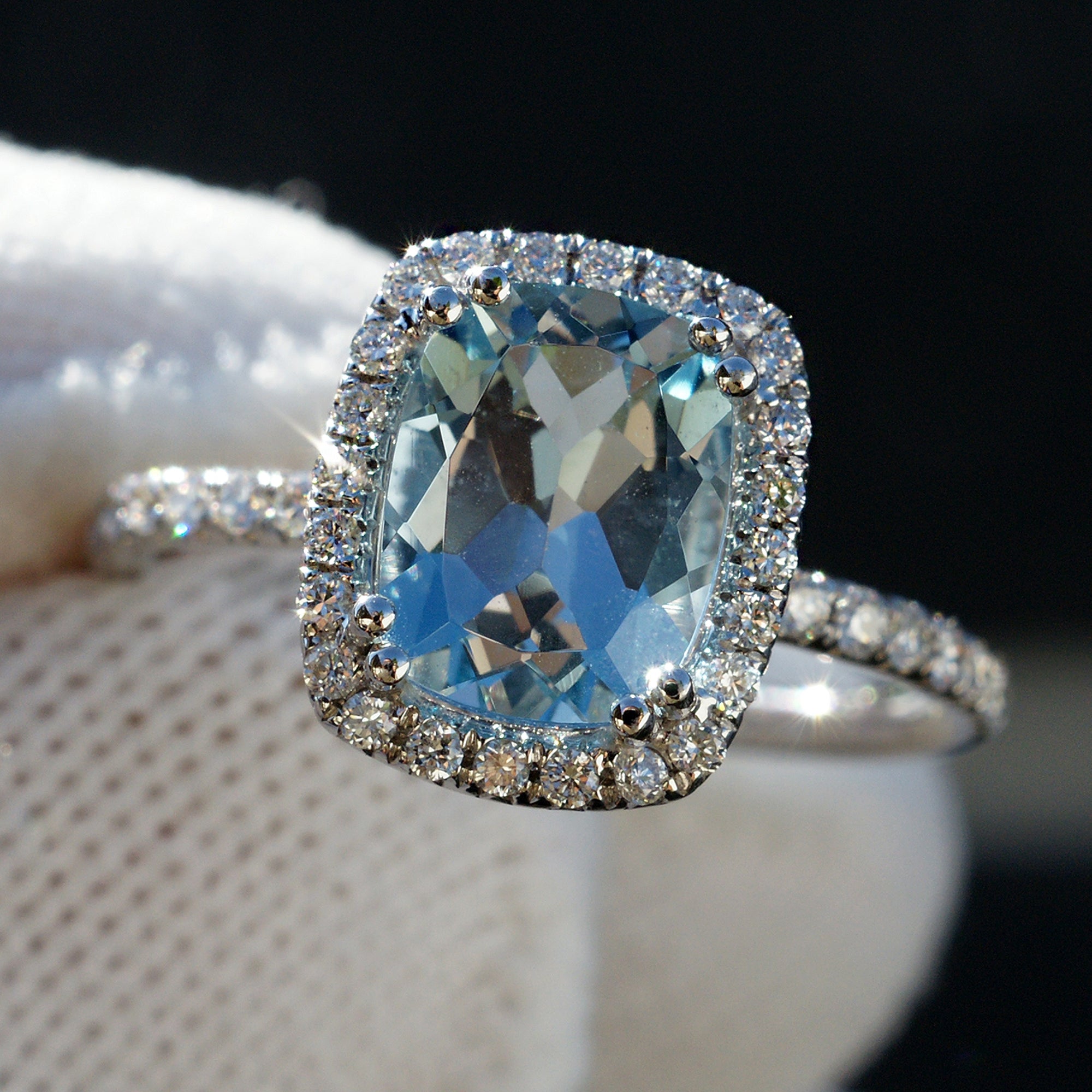 Cushion cut aquamarine engagement ring with diamond halo 18k white
