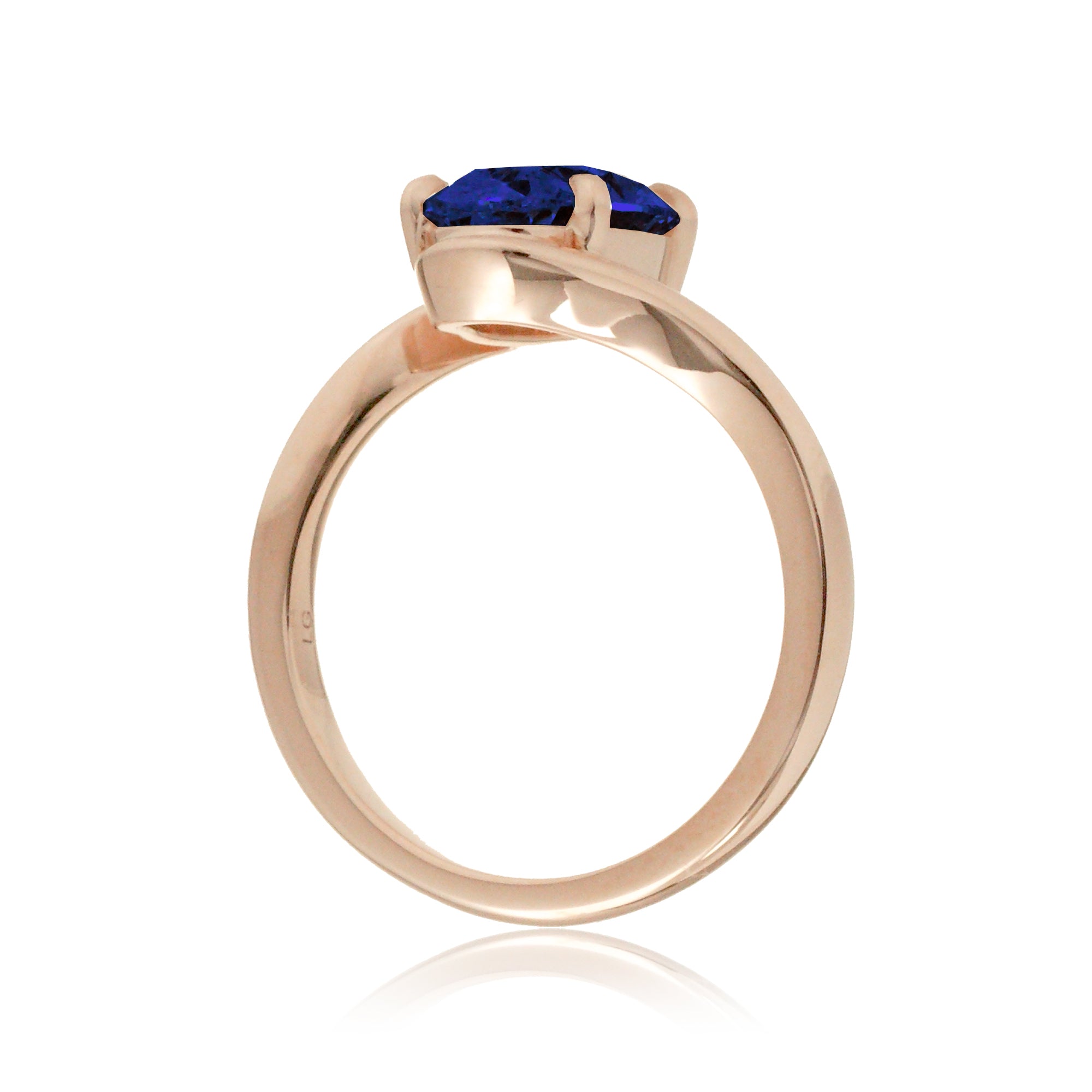 Contemporary oval blue sapphire engagement ring with twisting rose gold band