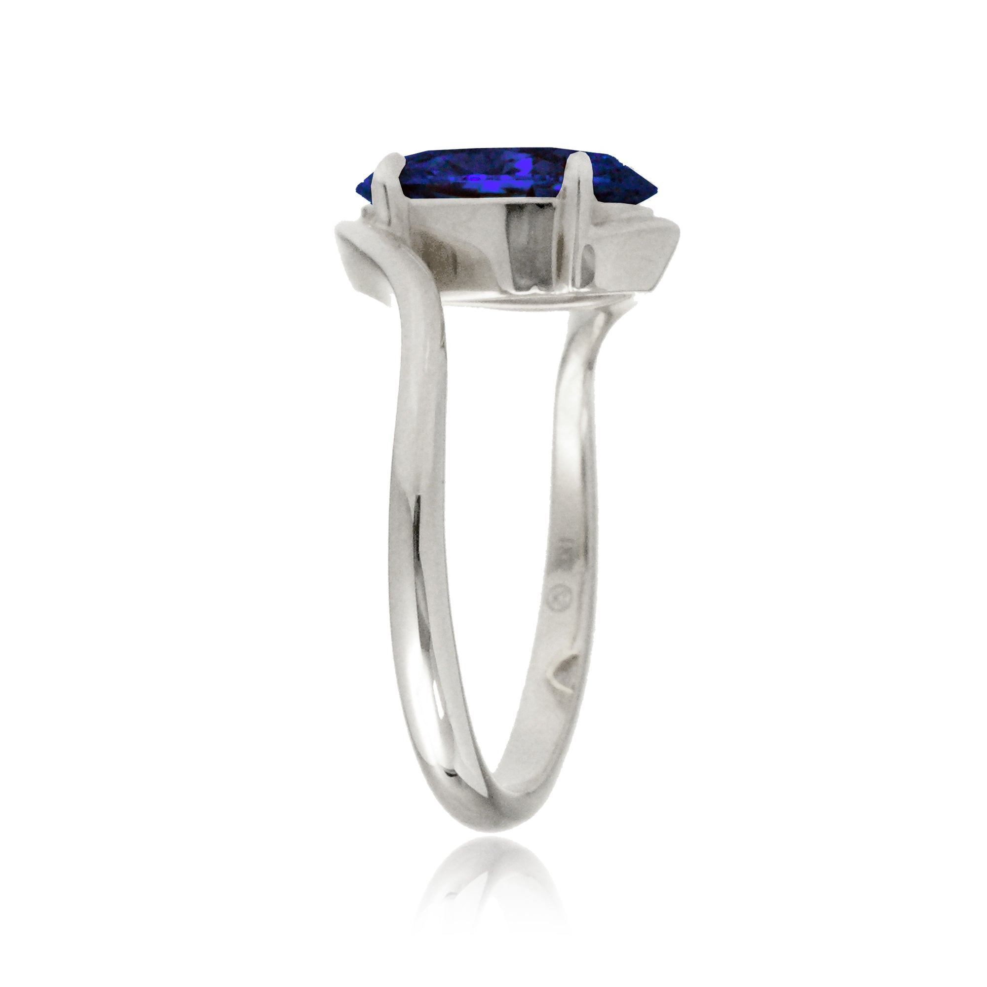 Oval blue sapphire ring in a modern bypass setting with white gold band