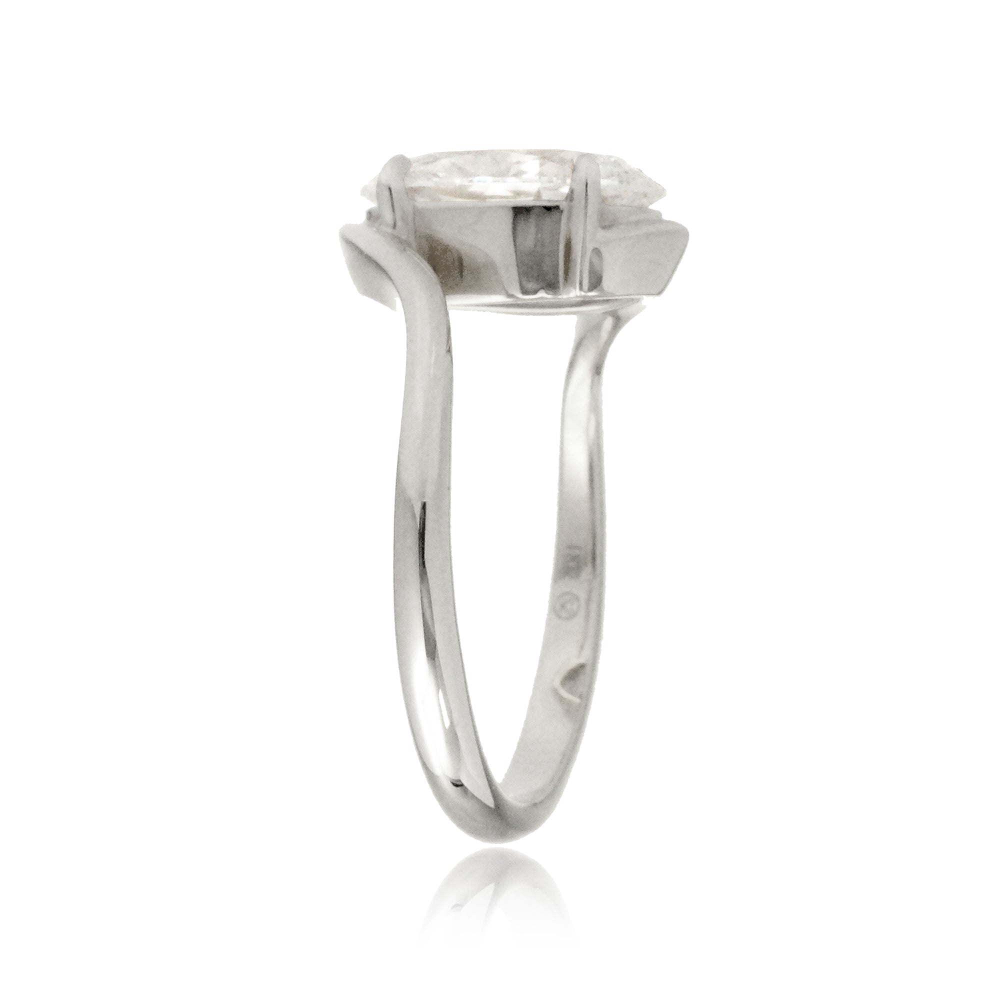 Oval diamond solitaire ring in a modern bypass setting with white gold band