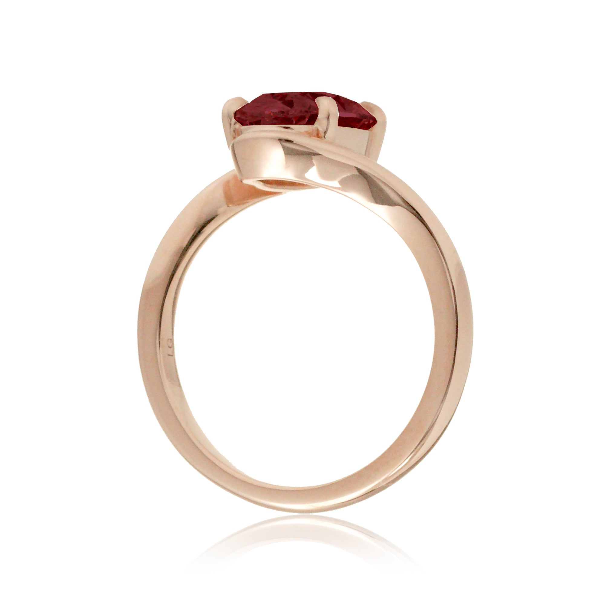 Modern bypass-style ring with deep red oval ruby and rose gold setting