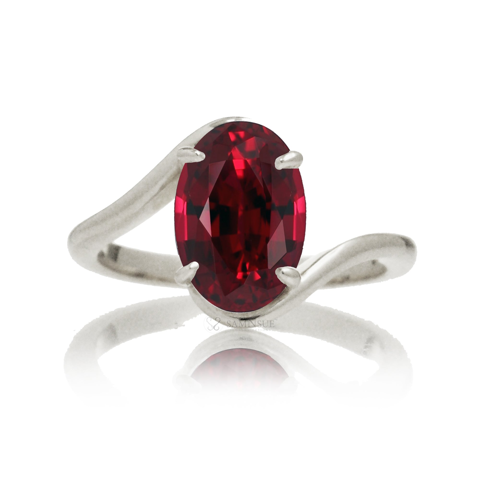 Oval ruby ring in a sleek bypass setting with white gold band