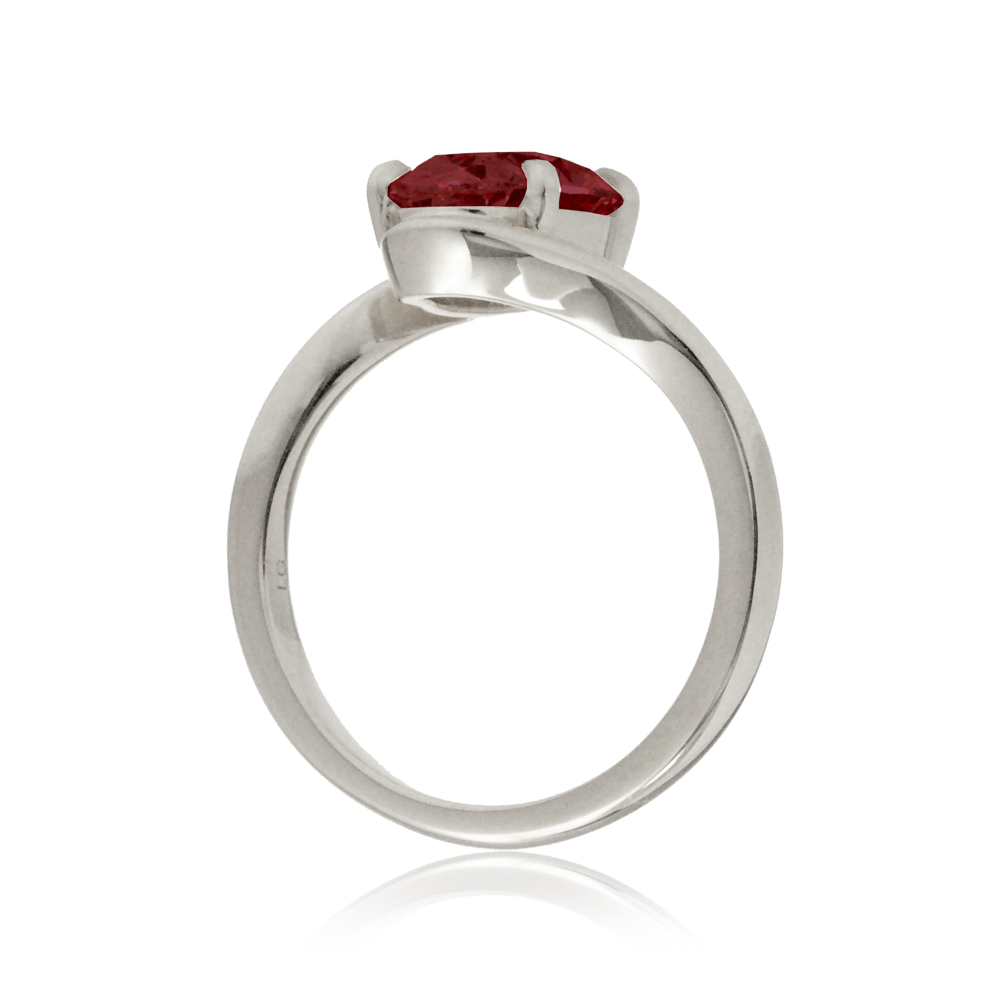 Oval ruby ring in a sleek bypass setting with white gold band