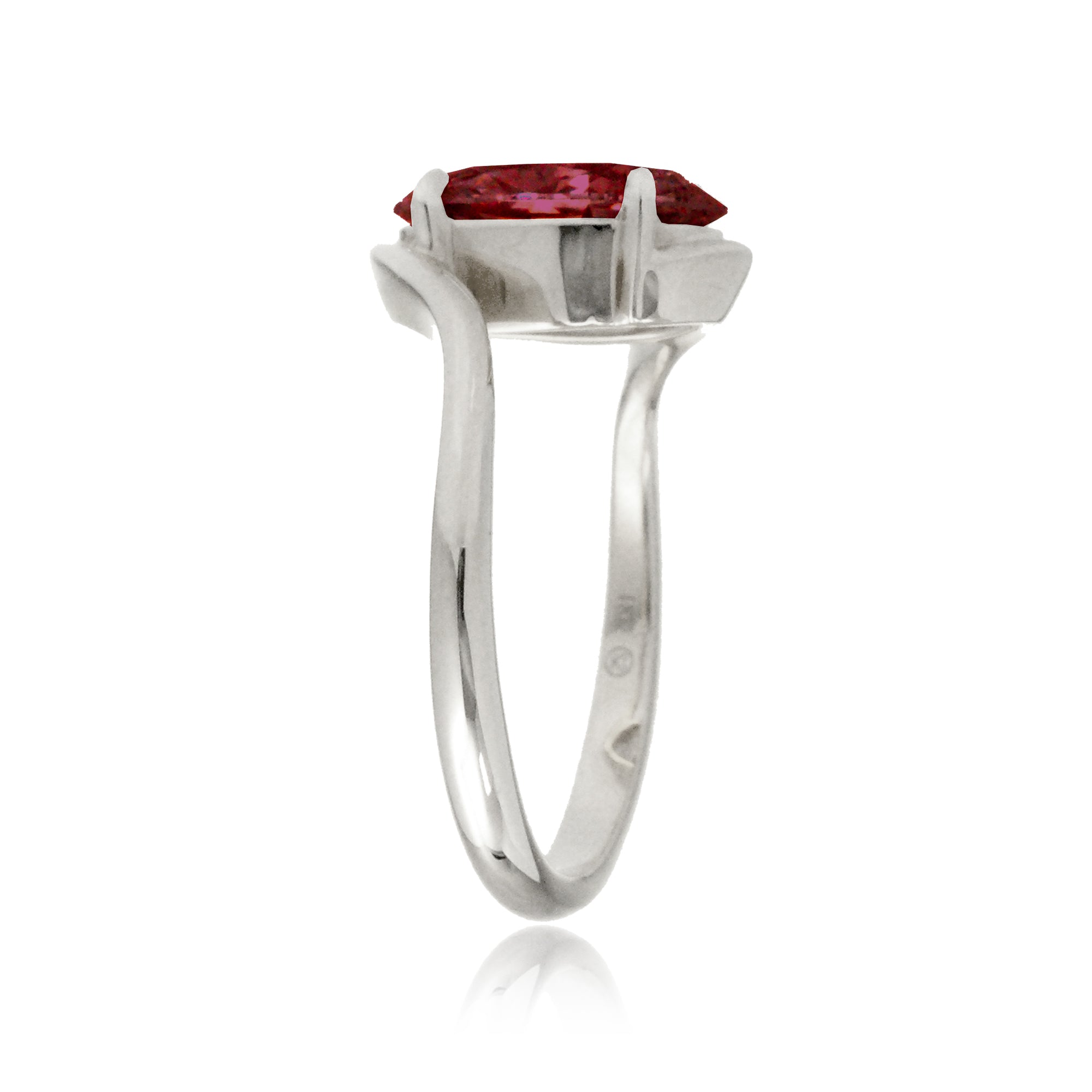 Oval ruby ring in a sleek bypass setting with white gold band