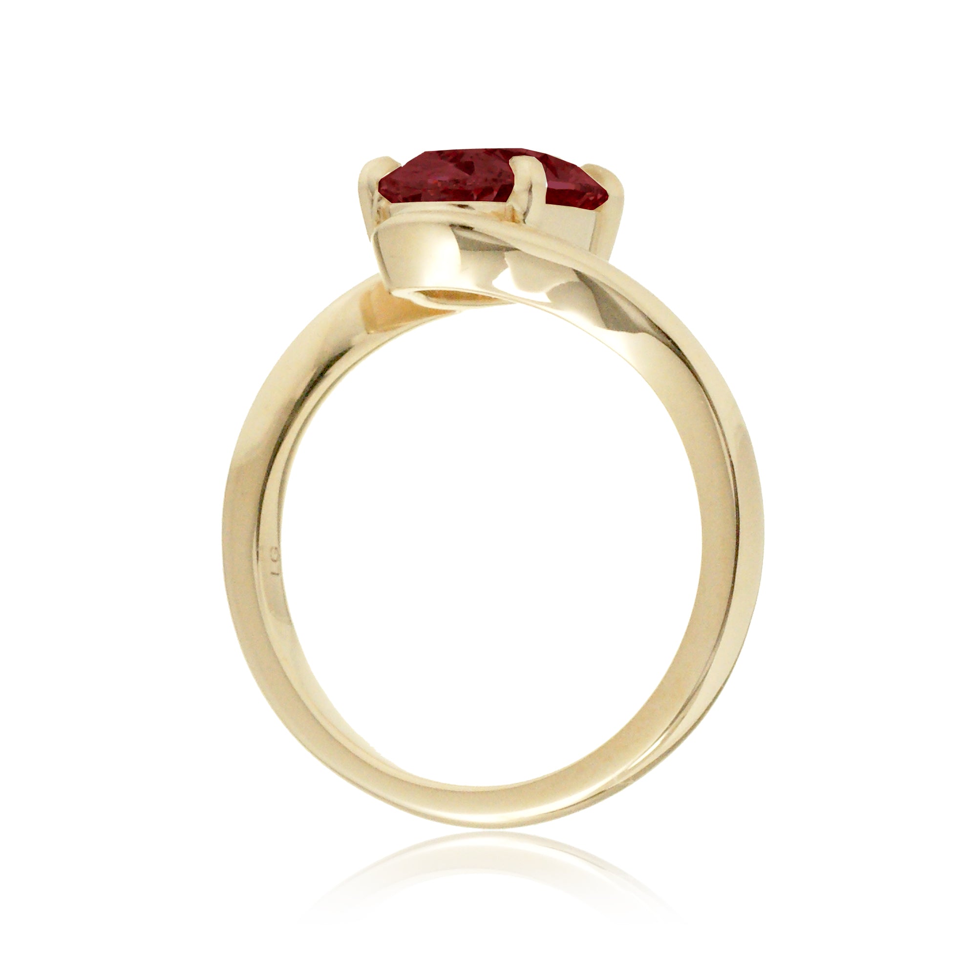 Elegant oval ruby engagement ring in yellow gold with contemporary wrap design