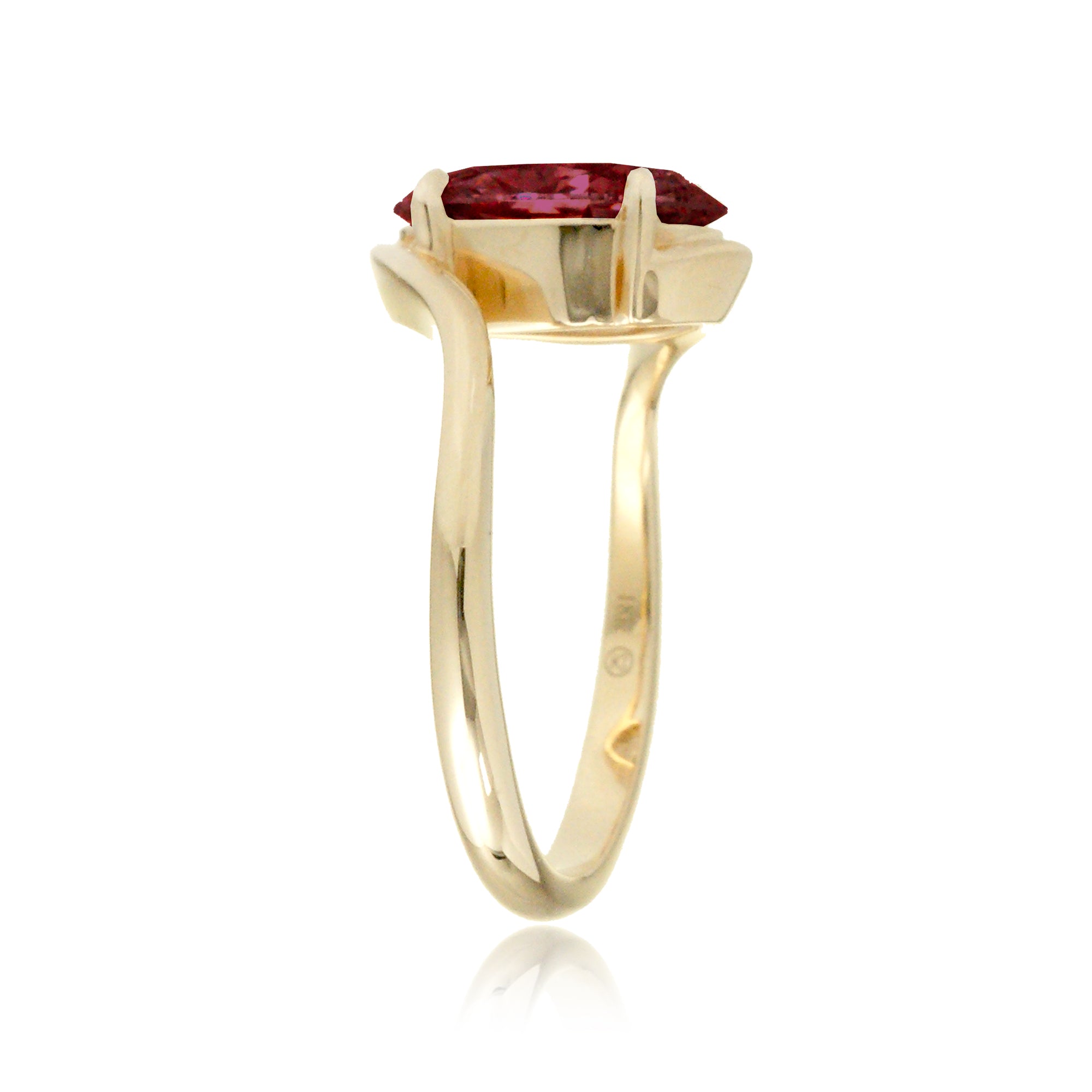 Elegant oval ruby engagement ring in yellow gold with contemporary wrap design
