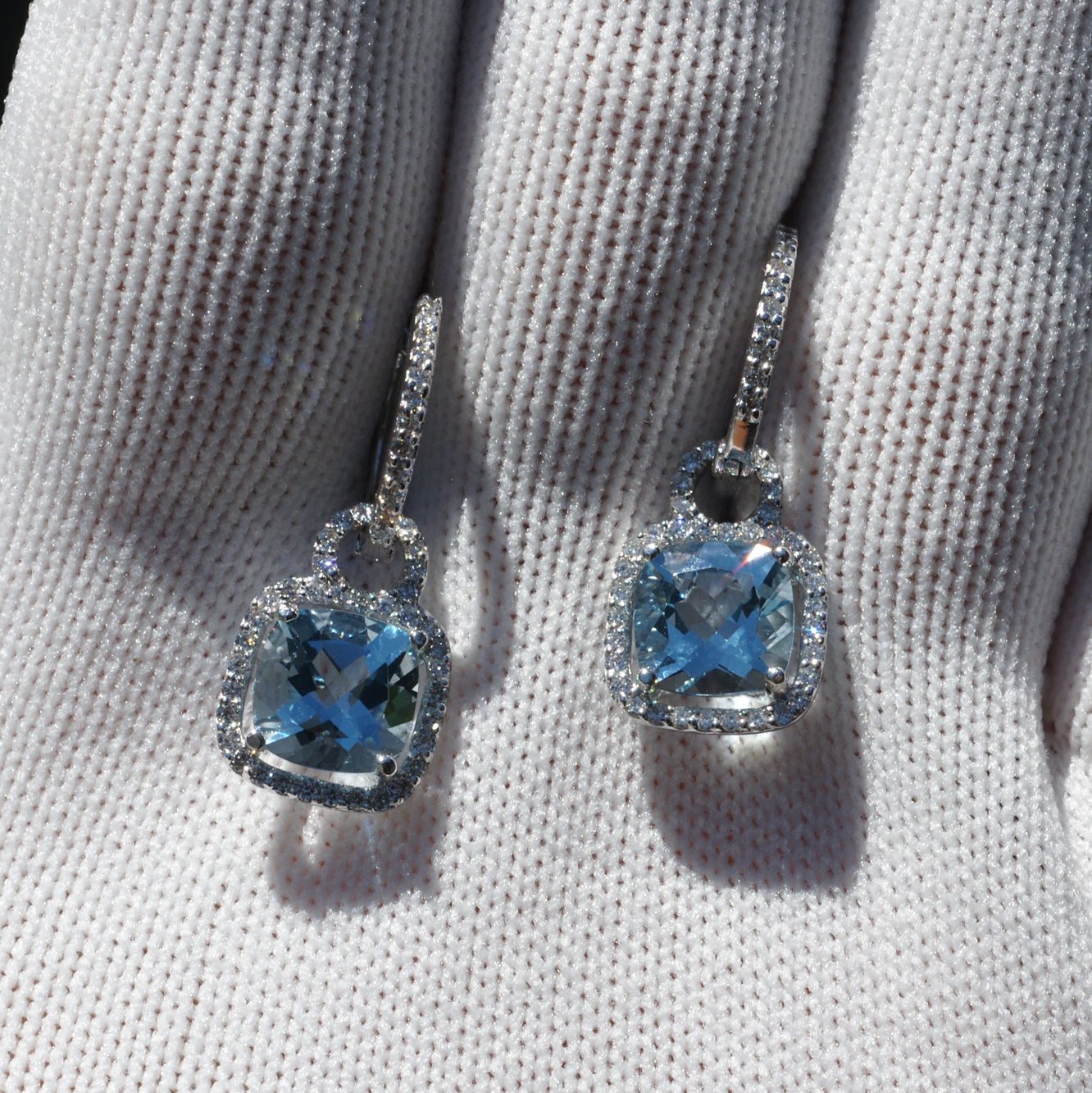 Cushion cut aquamarine dangles and diamond halo hoop earrings in white gold