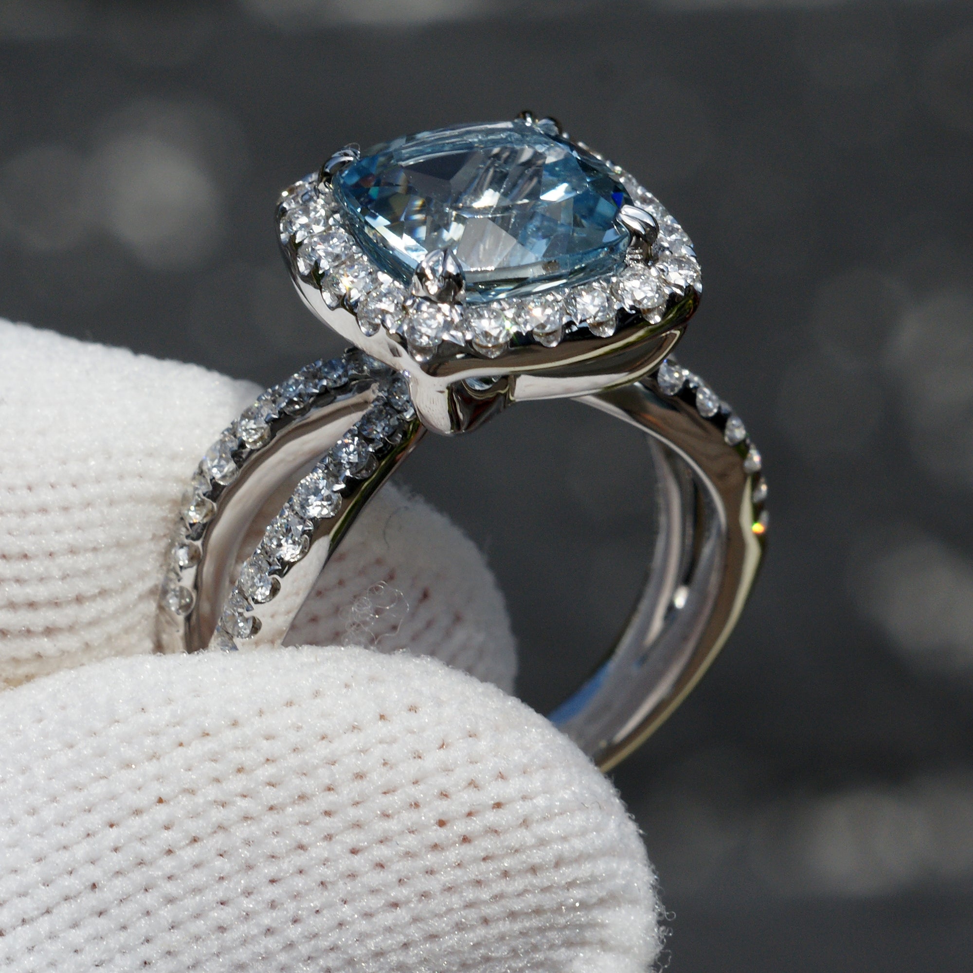 Natural aquamarine and diamond engagement anniversary ring in 18k white gold with a halo and splitband