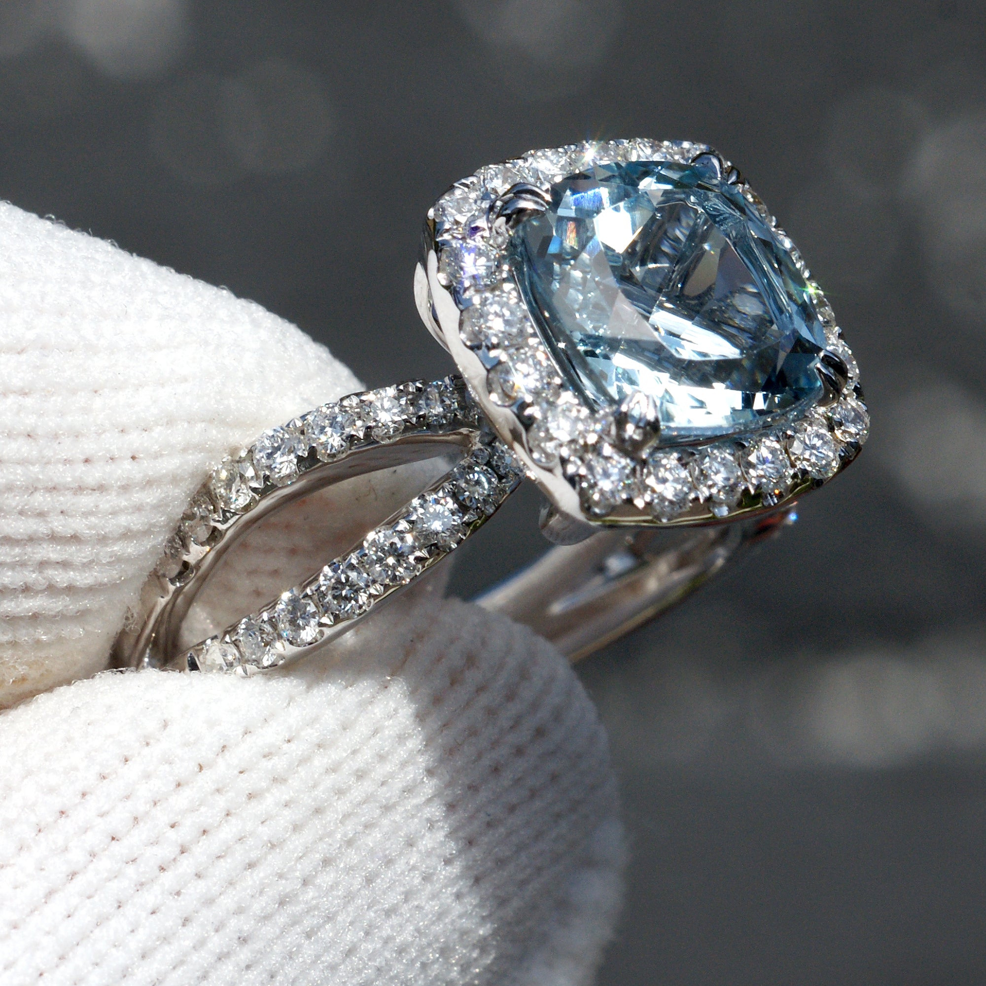 Natural aquamarine and diamond engagement anniversary ring in 18k white gold with a halo and splitband