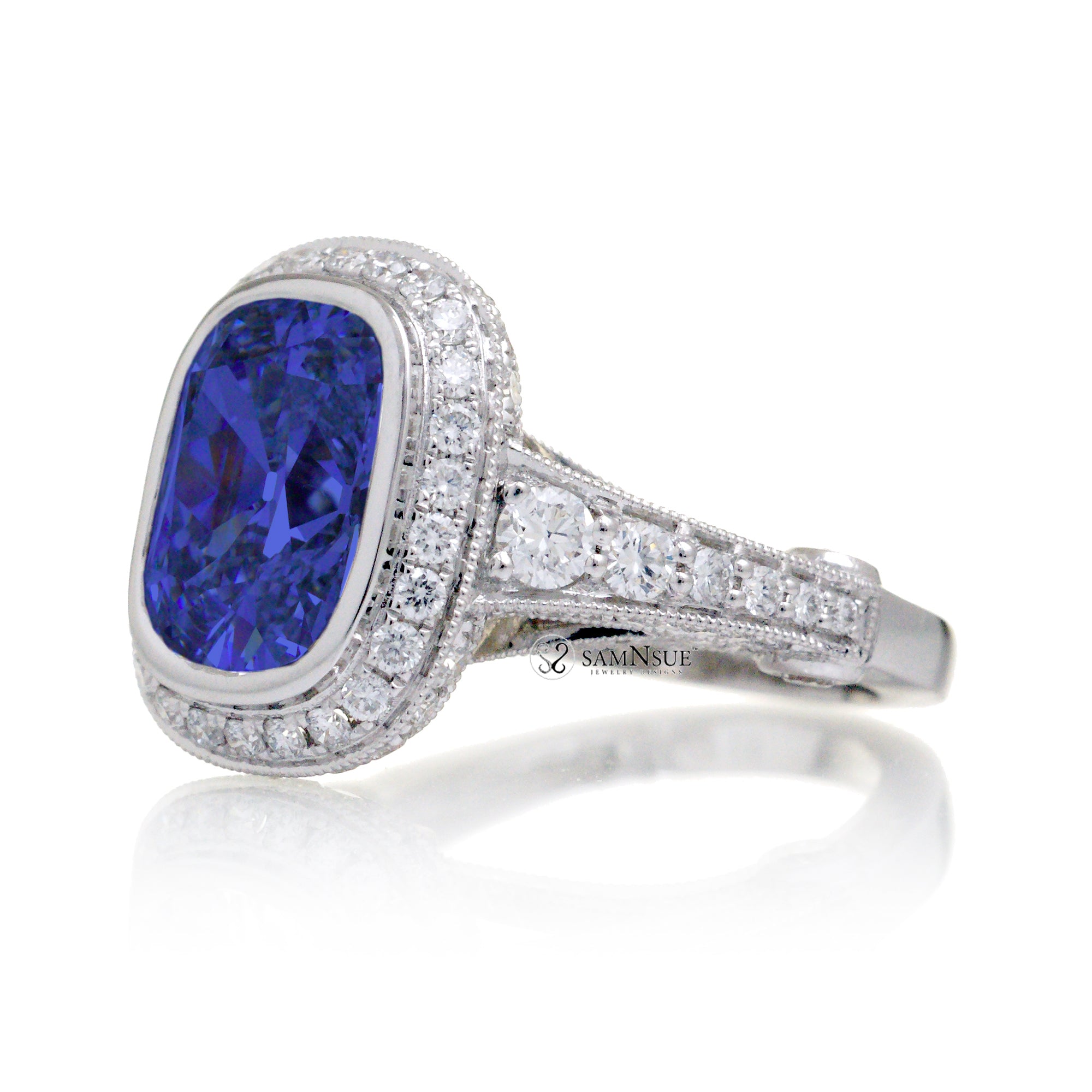 Cushion cut bezel blue sapphire diamond halo ring
