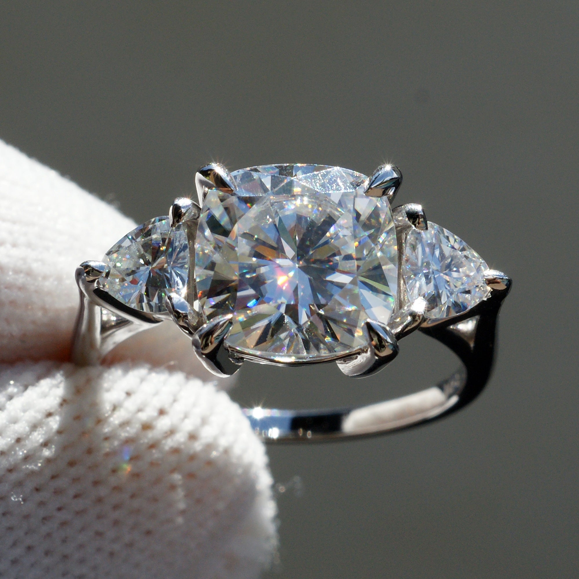 Cushion moissanite three stone ring with trillion on each side in white gold