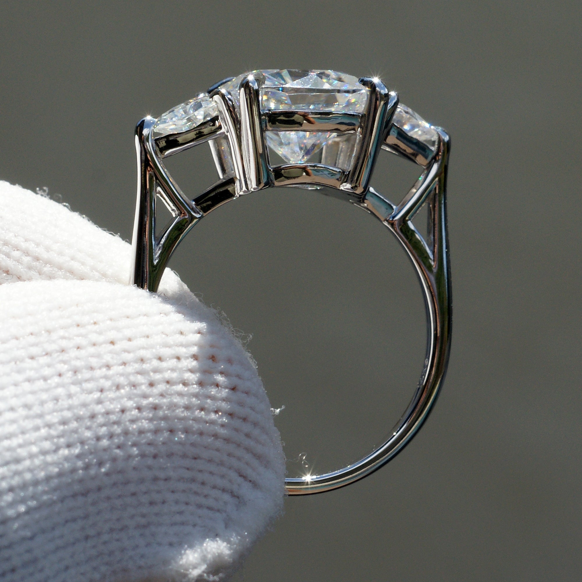 Cushion moissanite three stone ring with trillion on each side in white gold