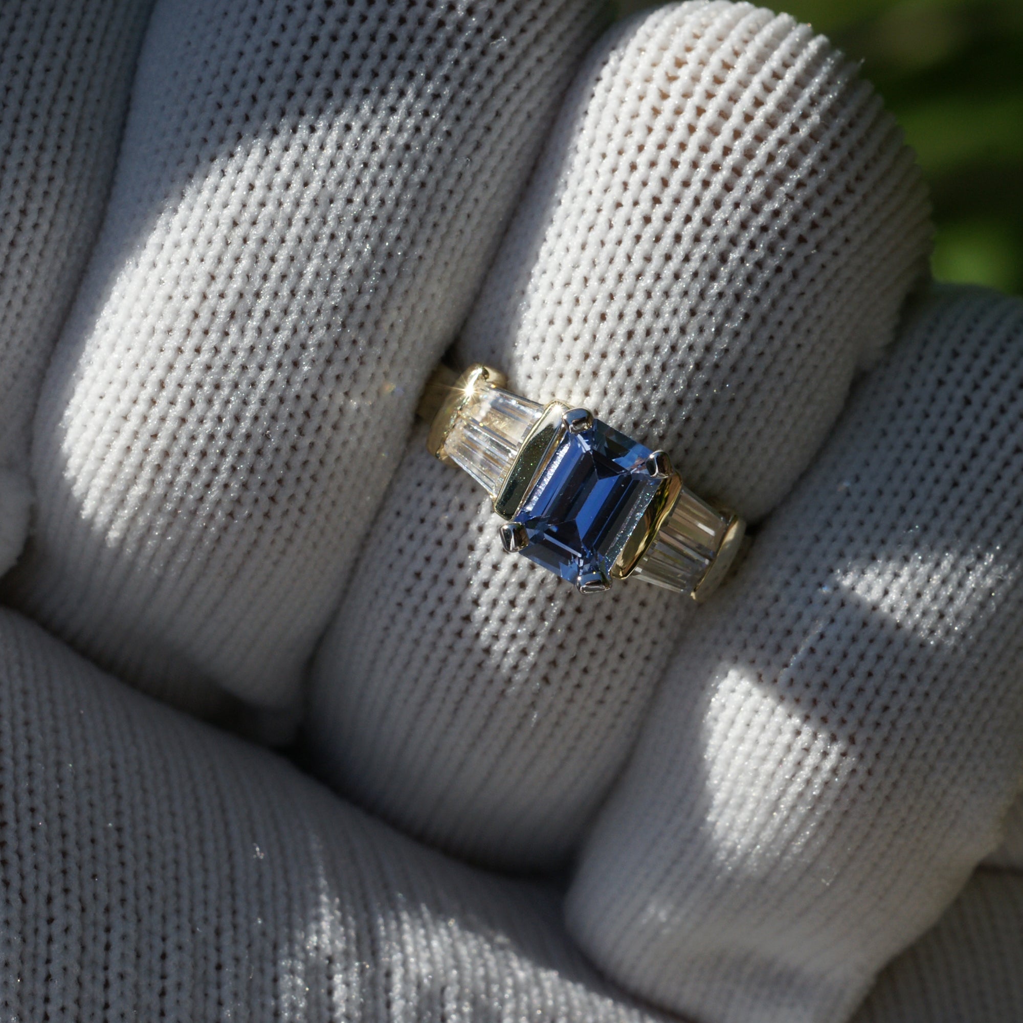 Natural sapphire and diamond baguette three stone ring in yellow gold