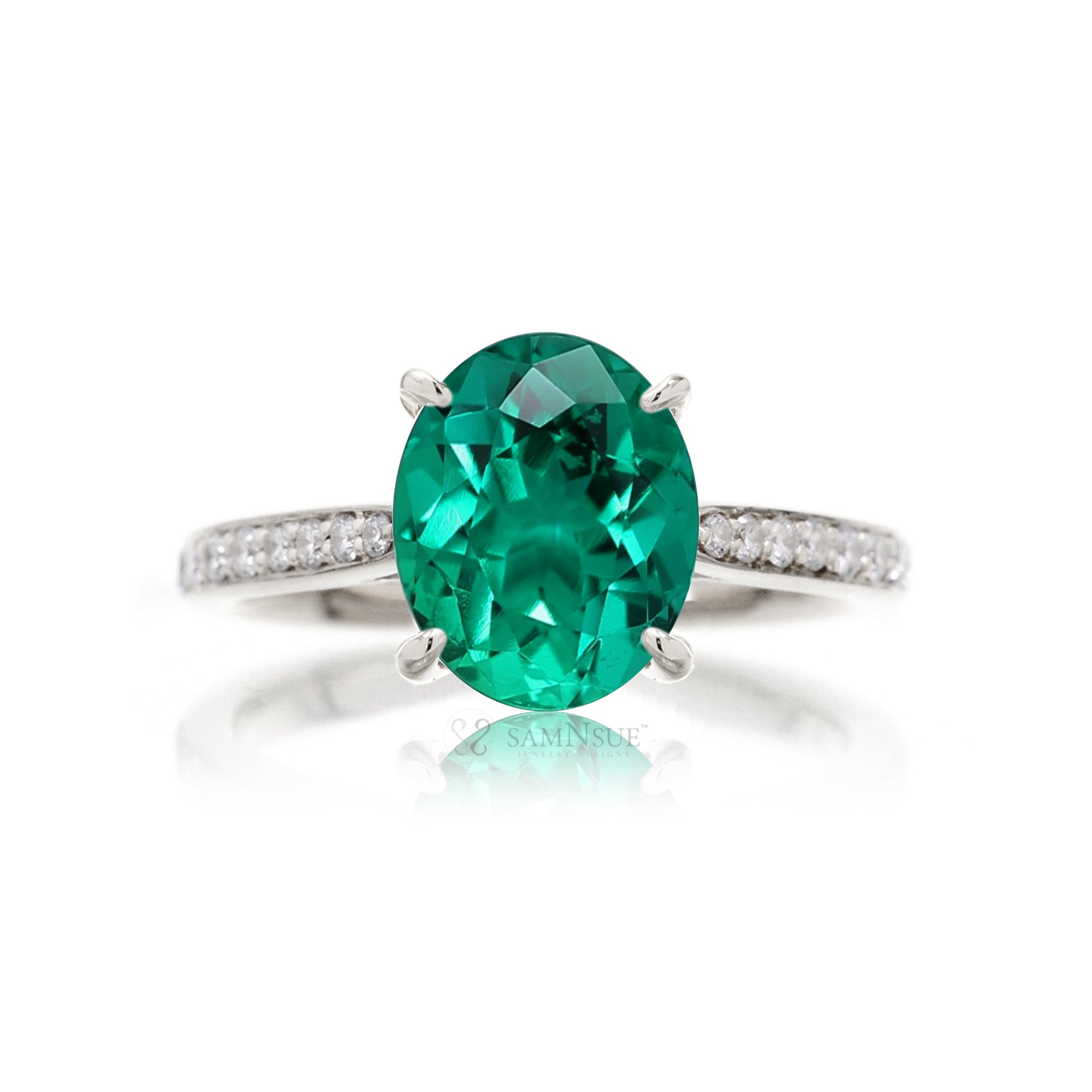 Oval cut emerald engagement ring with diamond hidden halo white gold