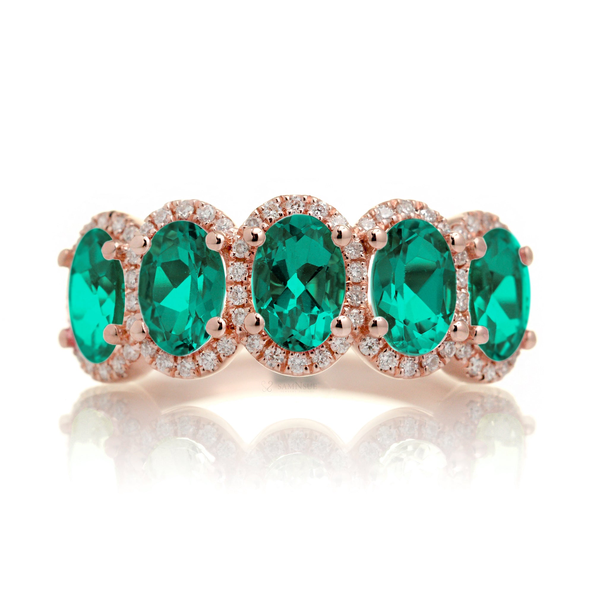 Anniversary band five stone oval emeralds with diamond halo in rose gold