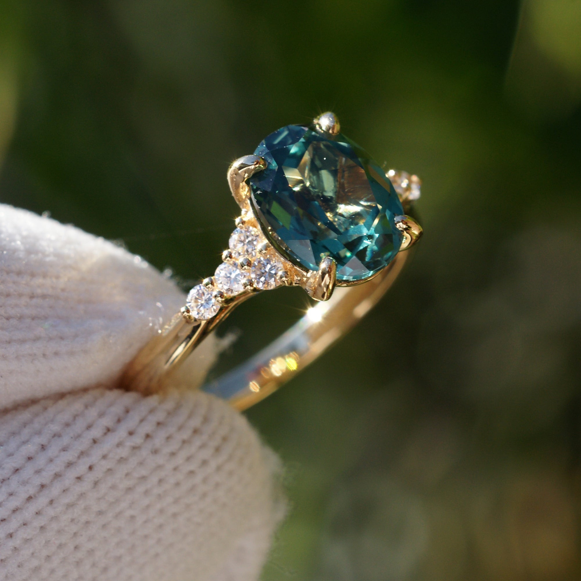 Oval cut green sapphire diamond three stone ring yellow gold