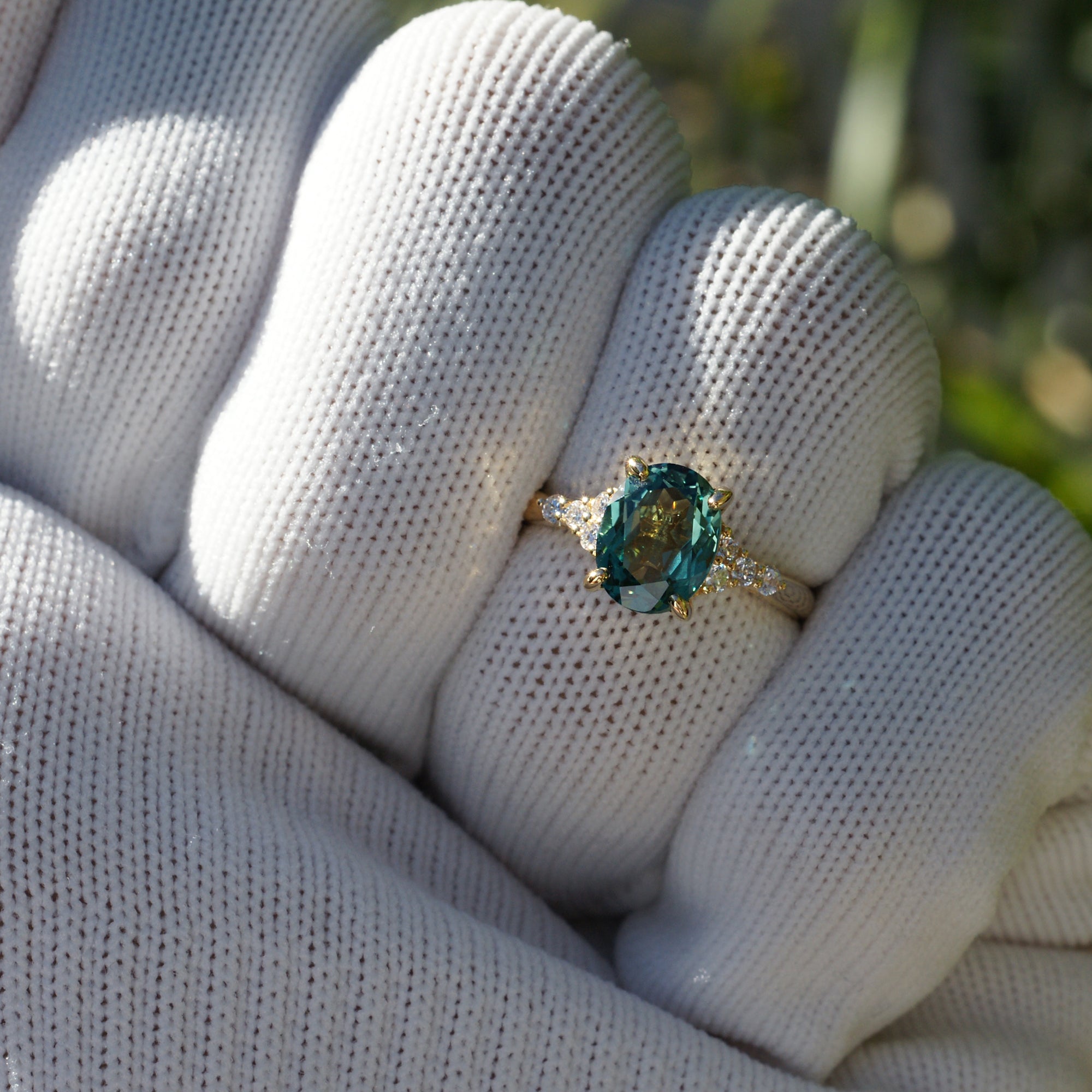 Oval cut green sapphire diamond three stone ring yellow gold