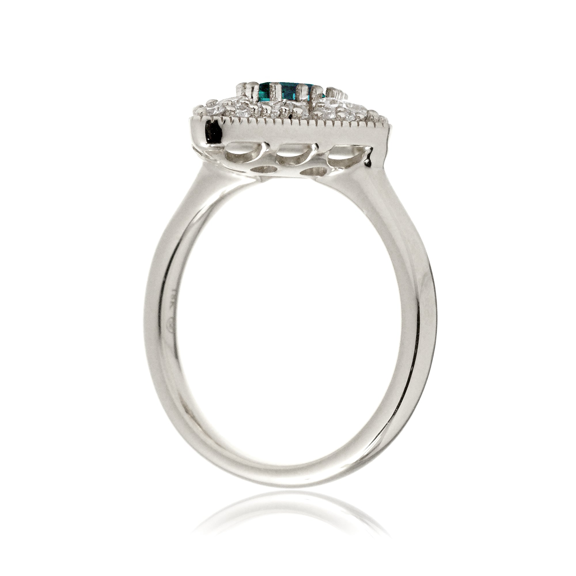 Kite cut green emerald and diamond vintage halo ring in white gold