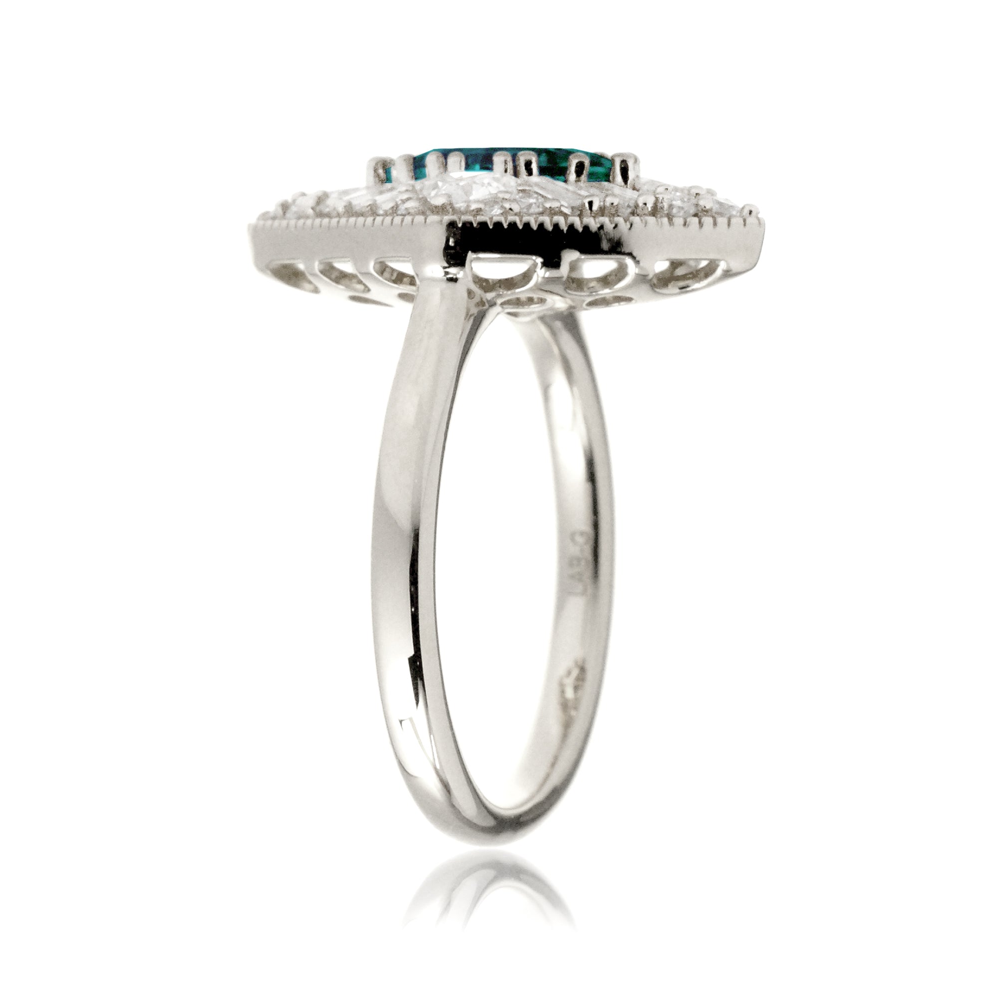 Kite cut green emerald and diamond vintage halo ring in white gold