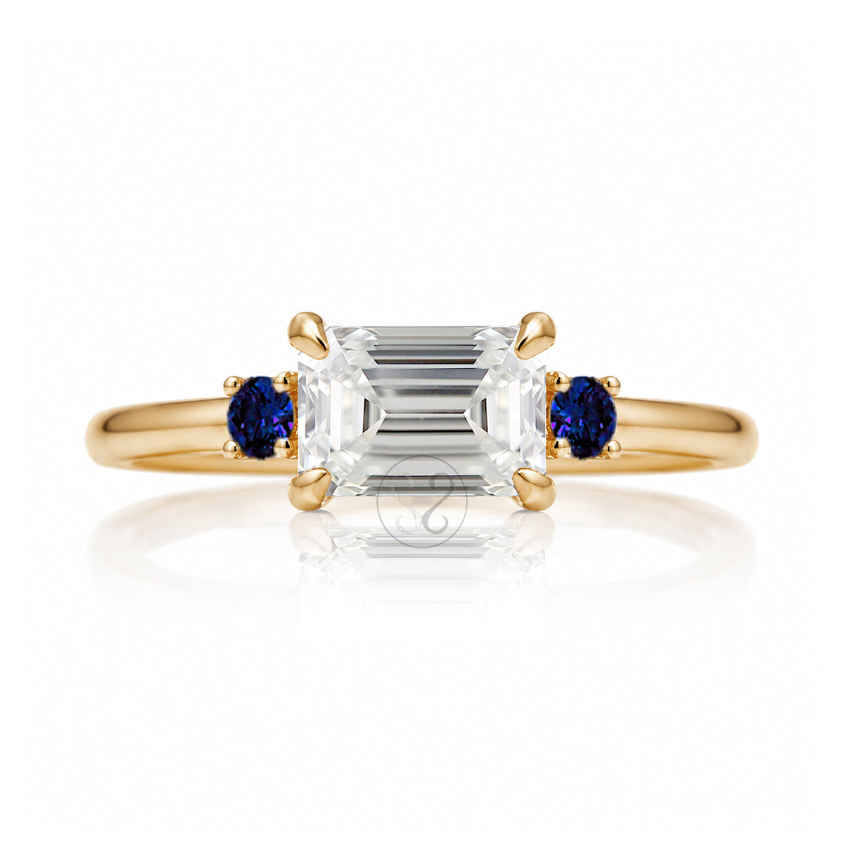 east-west emerald cut diamond three stone ring the Lena with side blue sapphires rose gold