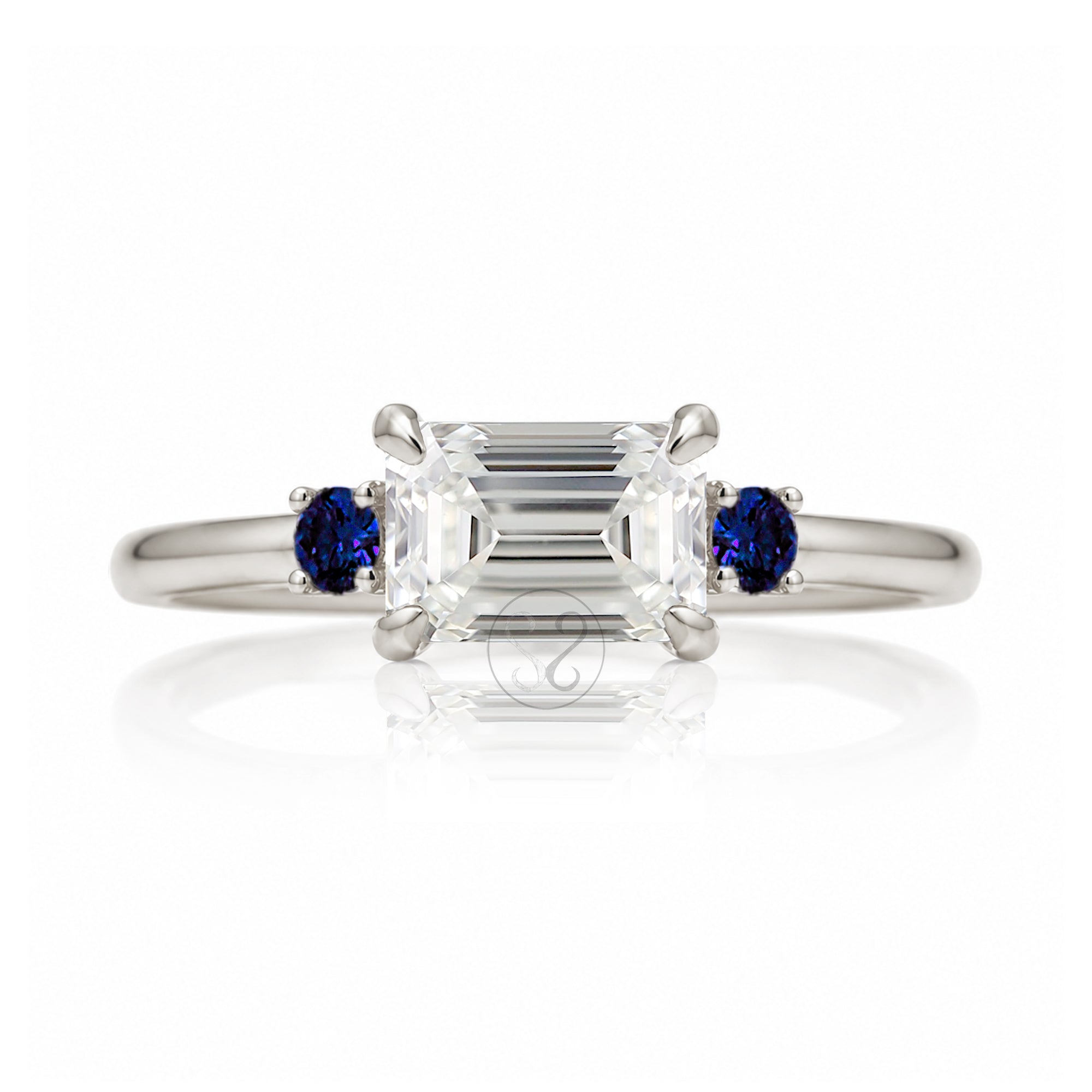 east-west emerald cut diamond three stone ring the Lena with side blue sapphires white gold