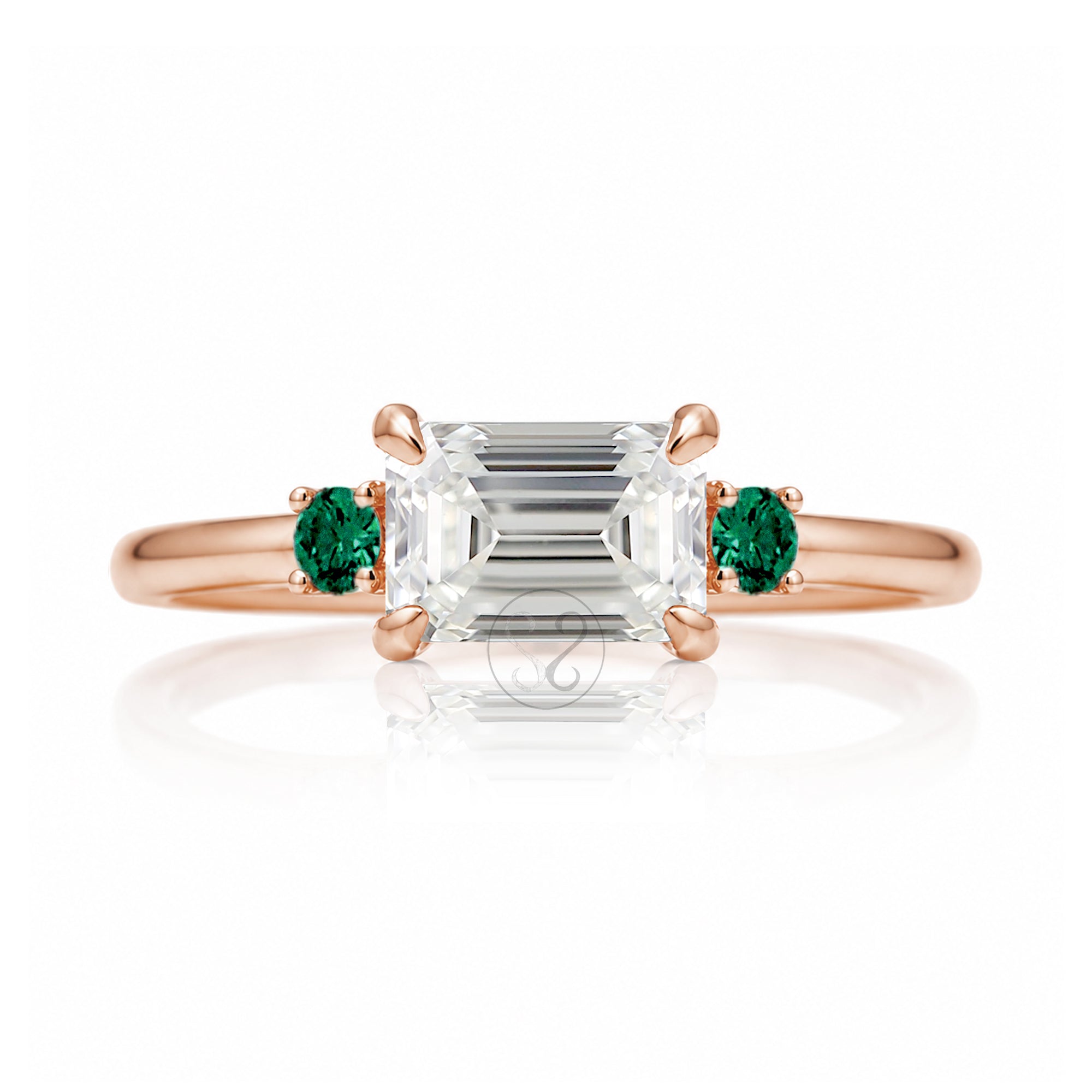 east-west emerald cut diamond three stone ring the Lena with side green emeralds rose gold