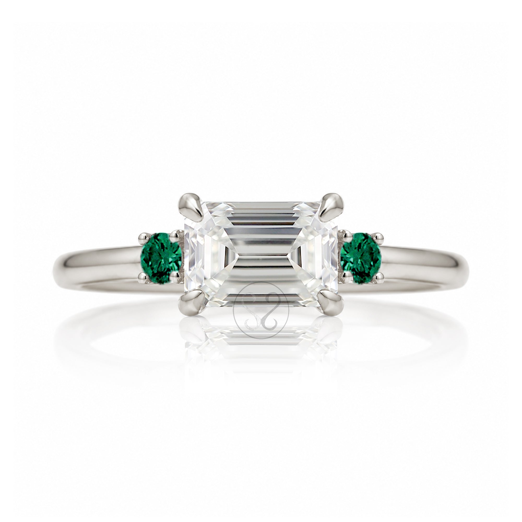 east-west emerald cut diamond three stone ring the Lena with side green emeralds white gold