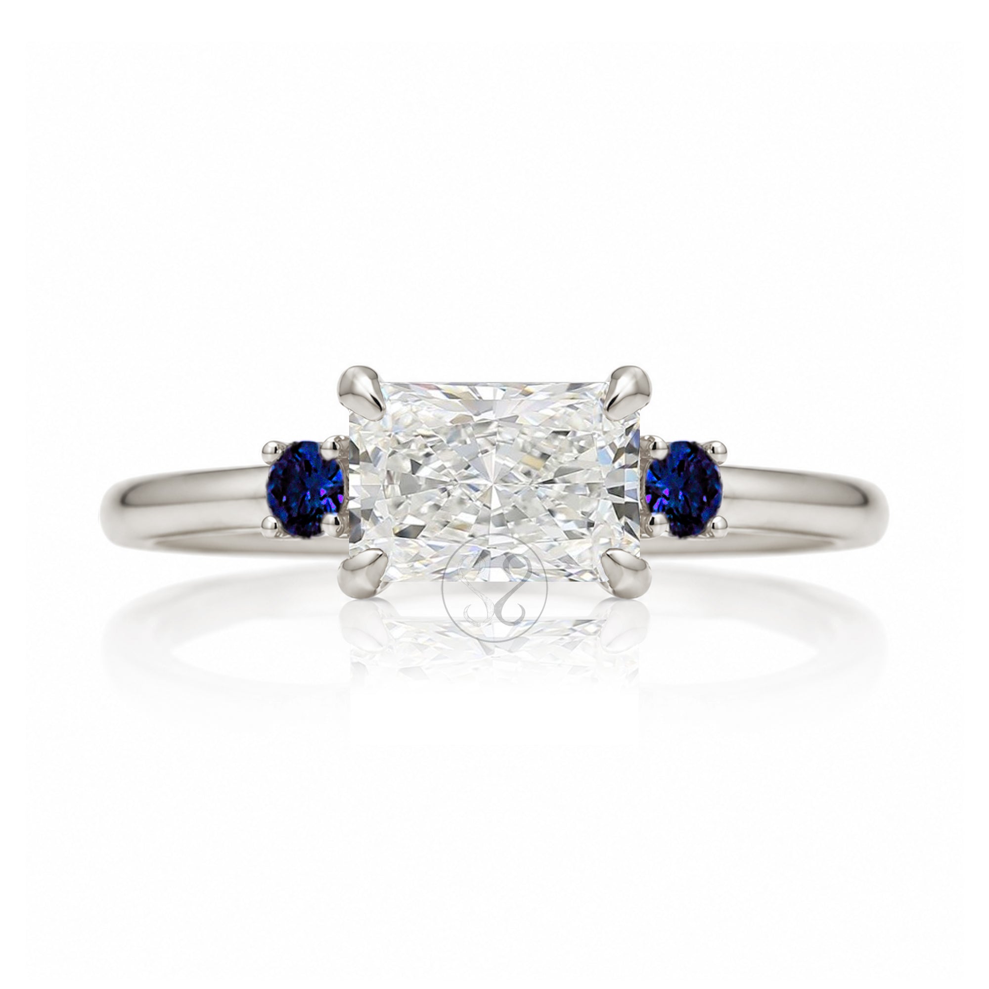 east-west radiant cut lab-grown diamond threestone ring with side blue sapphires white gold