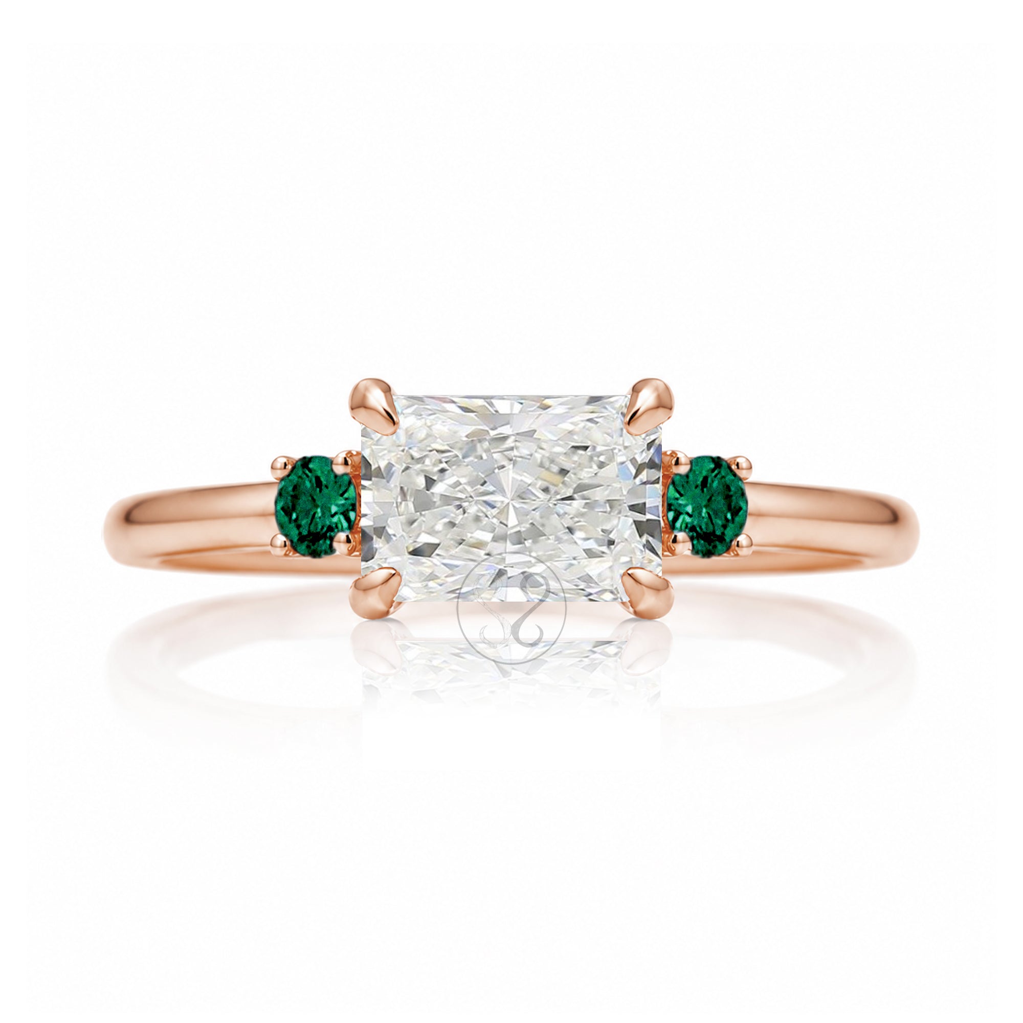 east-west radiant cut lab-grown diamond threestone ring with green emerald rose gold
