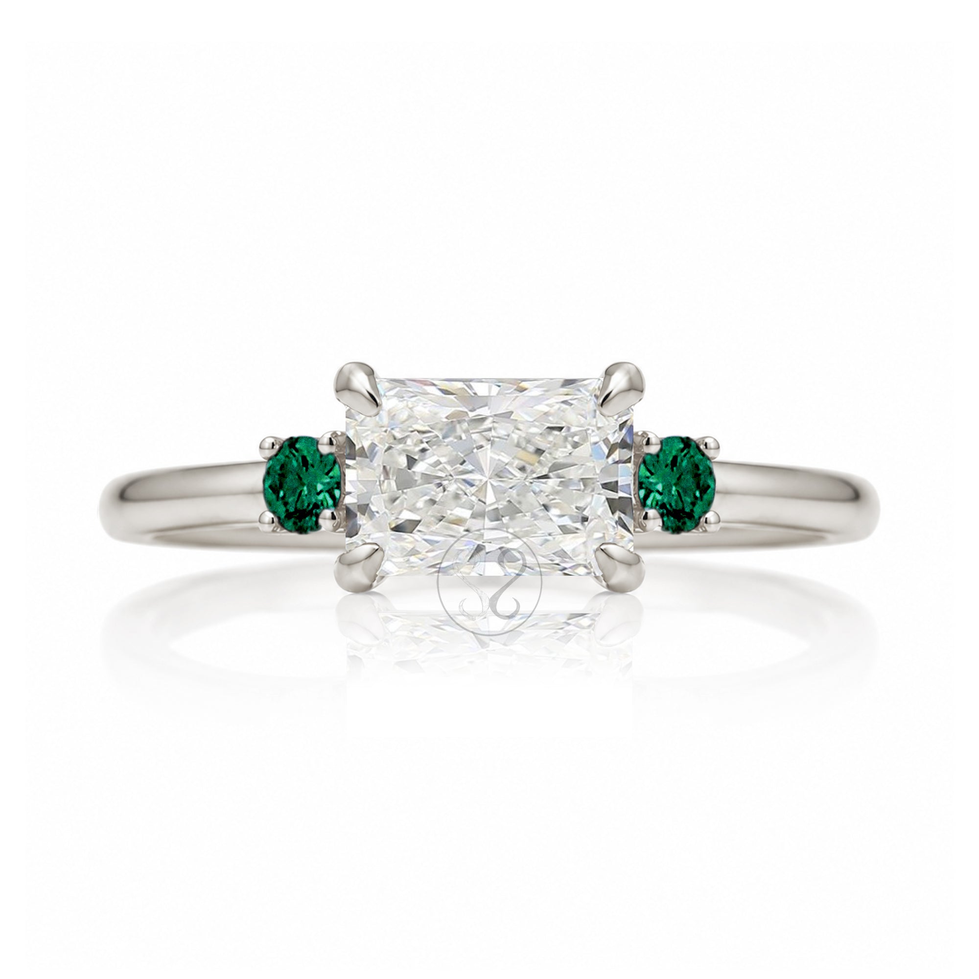 east-west radiant cut lab-grown diamond threestone ring with green emerald white gold