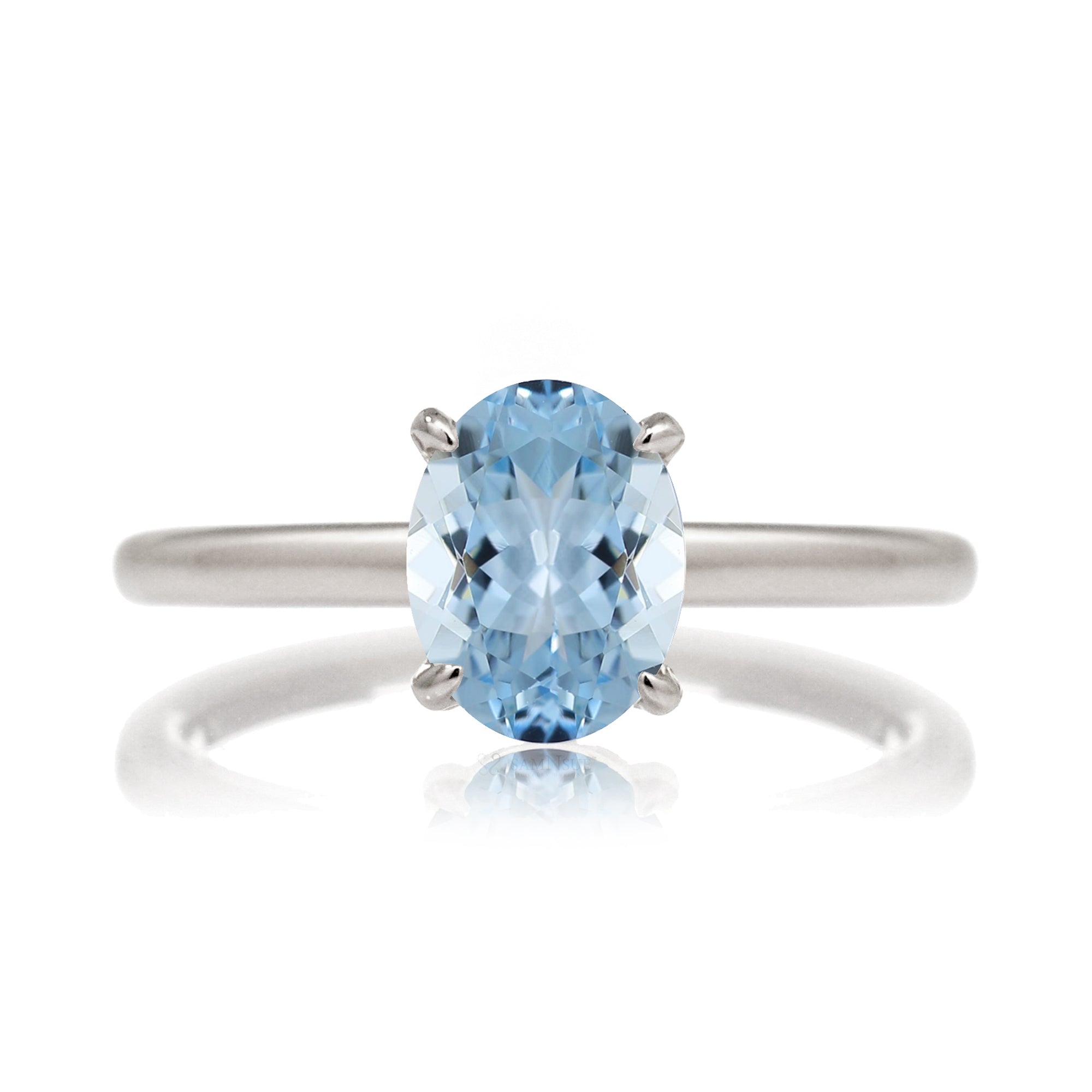 Oval aquamarine ring with diamond hidden halo and rounded band white gold