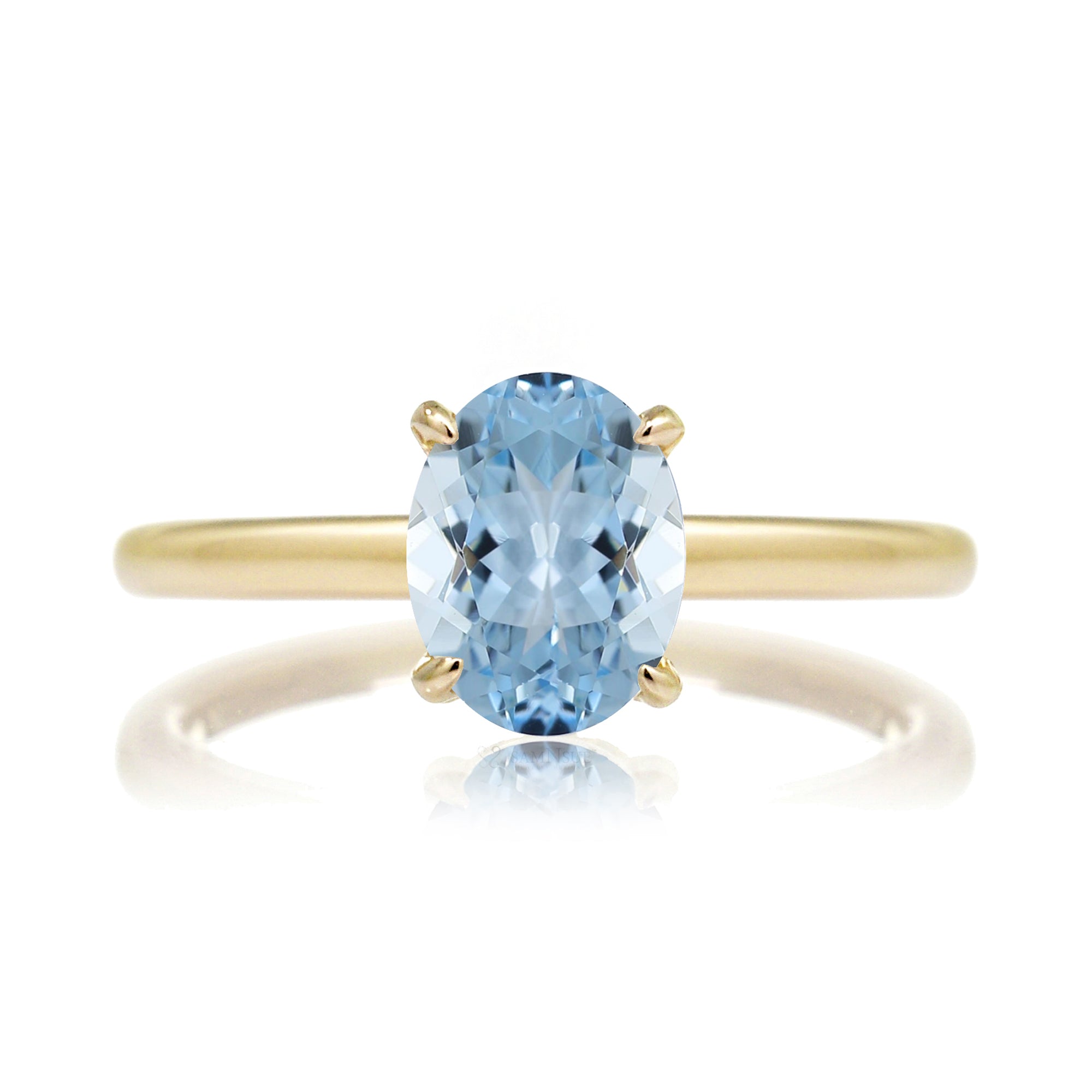Oval aquamarine ring with diamond hidden halo and rounded band yellow gold