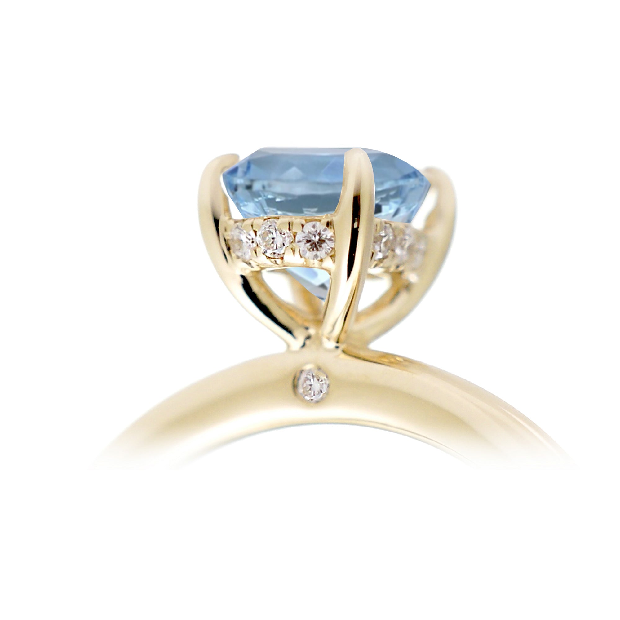 Oval aquamarine ring with diamond hidden halo and rounded band yellow gold