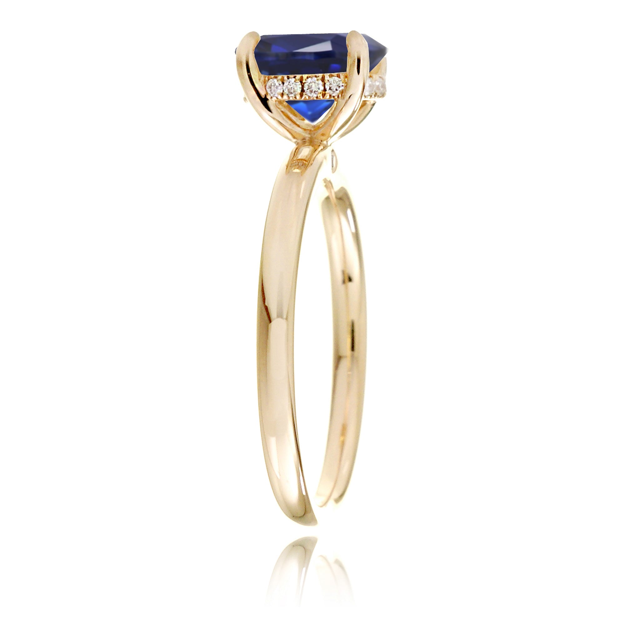 Oval cut blue sapphire engagement ring with a diamond hidden halo and solid band yellow gold