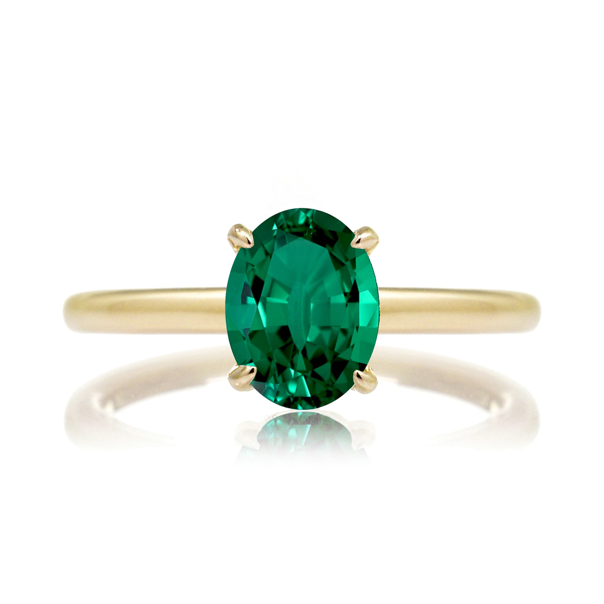Oval cut green emerald ring with diamond hidden halo on yellow gold