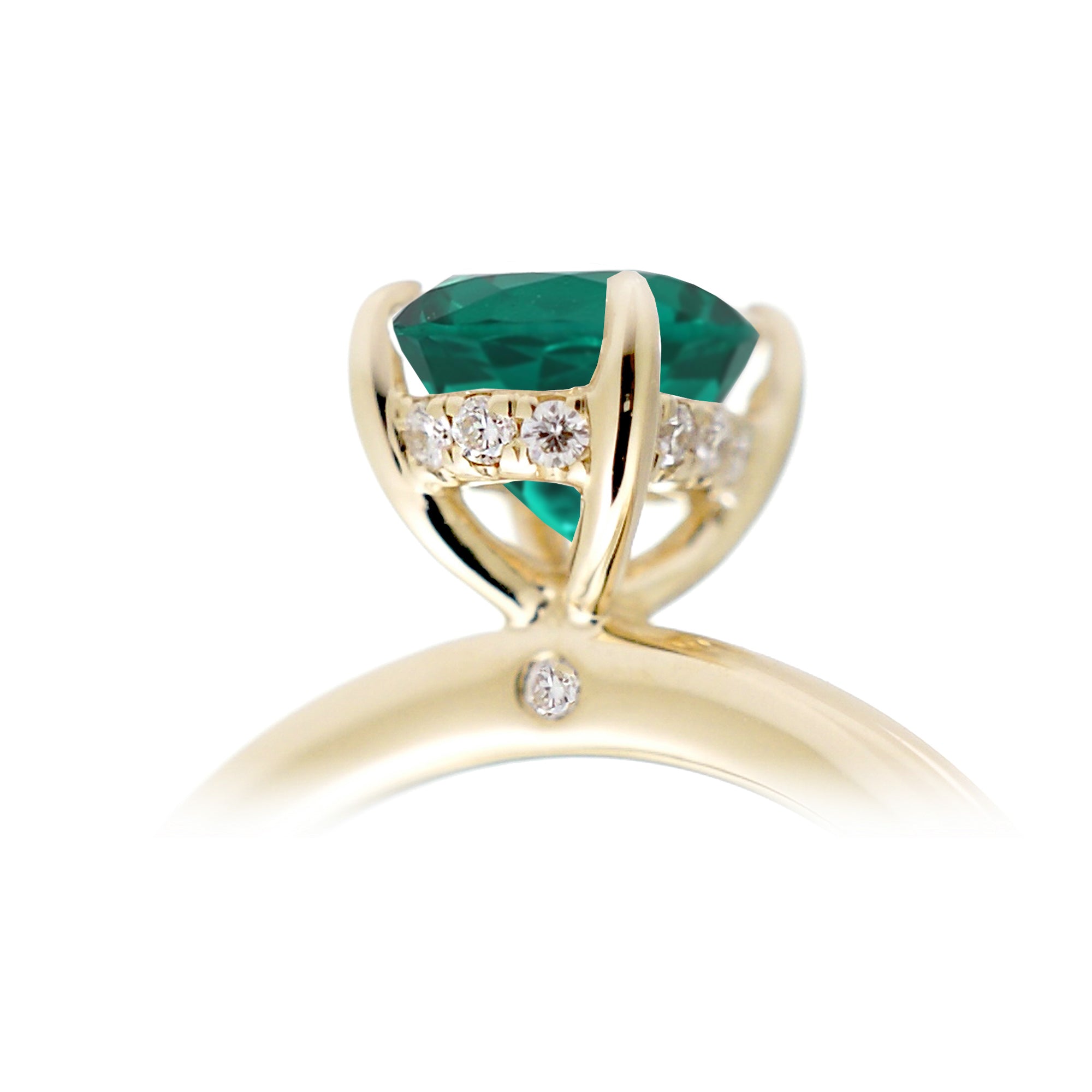 Oval cut green emerald ring with diamond hidden halo on yellow gold