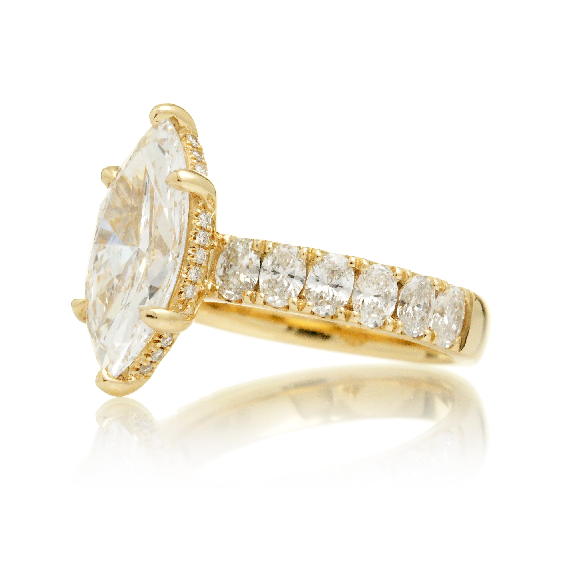 Large marquise cut diamond ring with wide oval diamond band and hidden diamond halo yellow gold