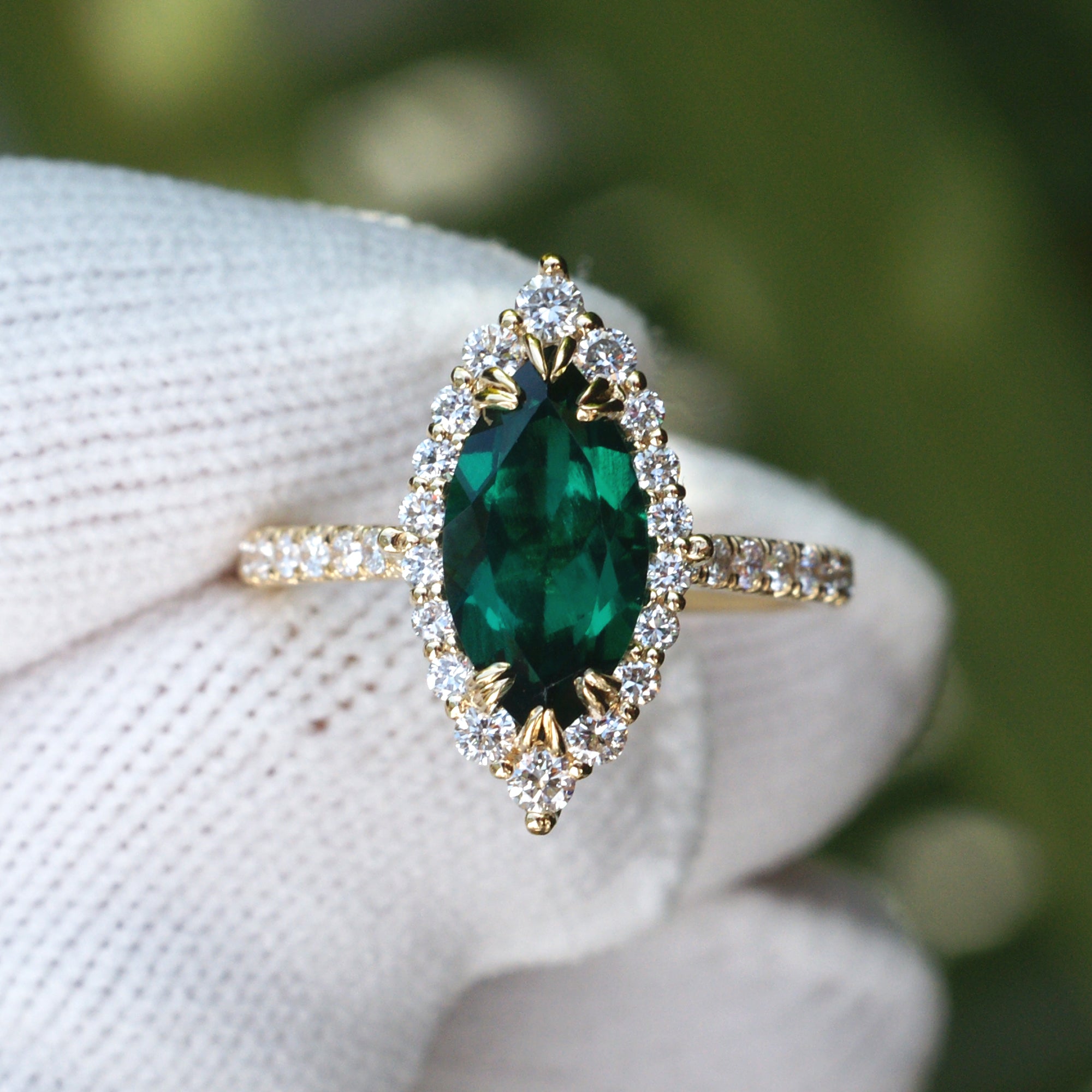 Marquise emerald with diamond halo gradual diamond band yellow gold