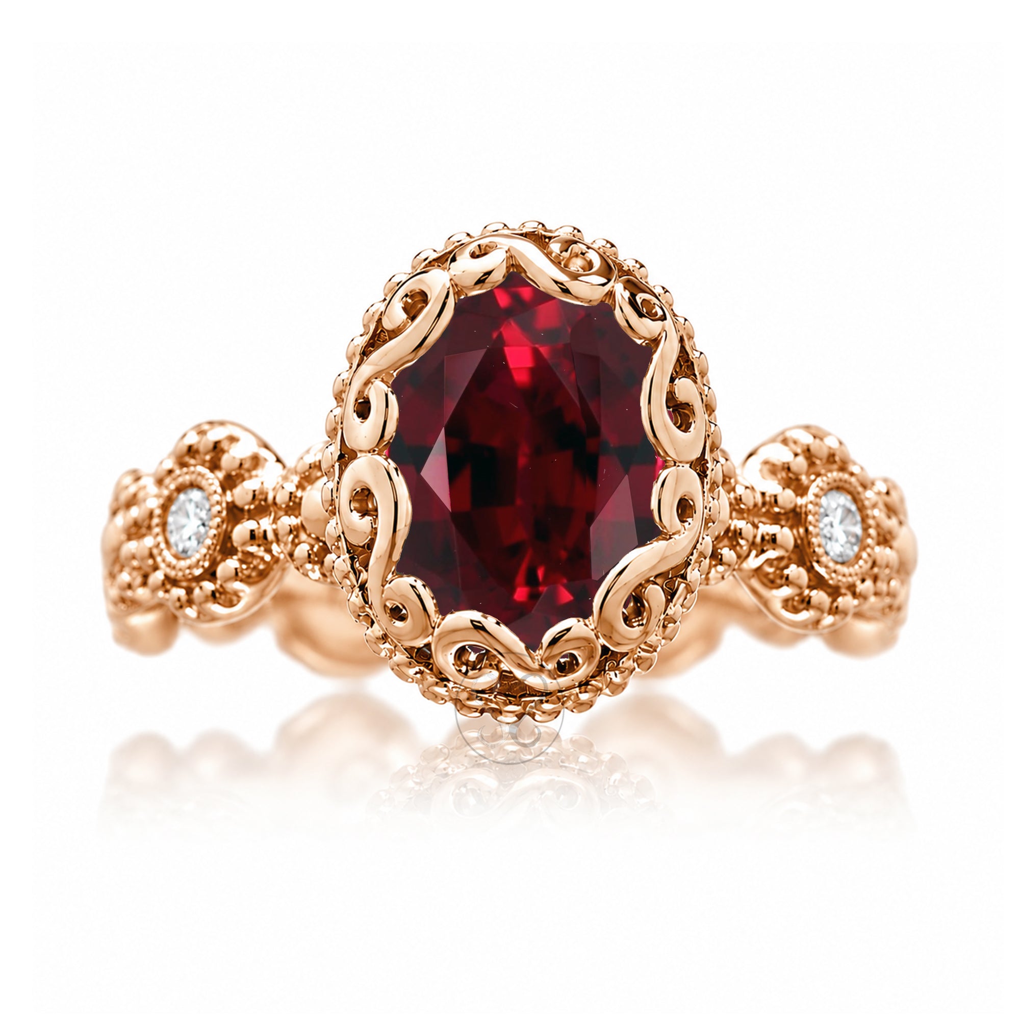 An ornate rose gold ring featuring a large oval-cut deep red gemstone in a decorative filigree setting, with two small round clear stones on the shoulders, shown on a white background with a soft reflection.