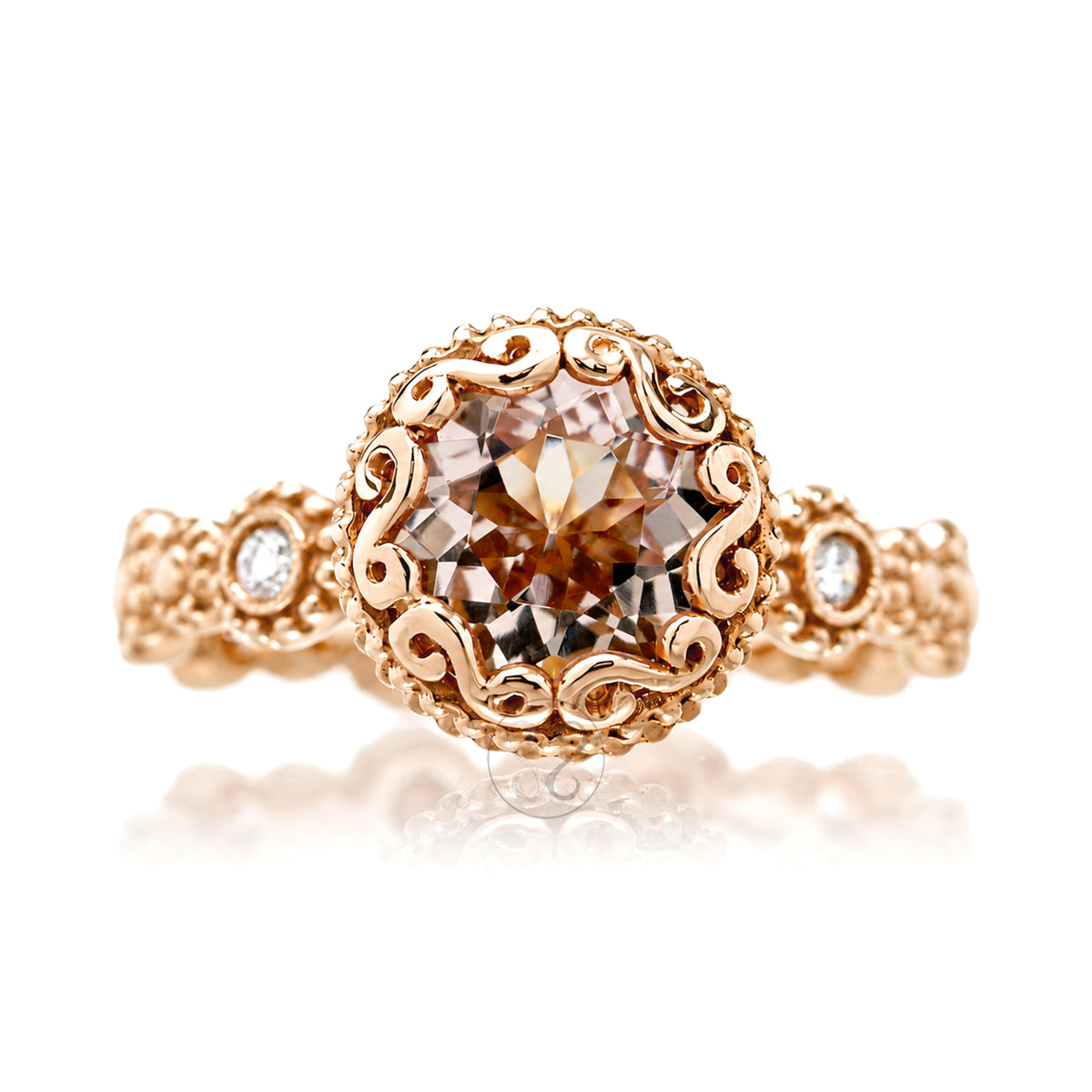 An ornate rose gold ring featuring a large round-cut brown gemstone in a detailed filigree setting, with small accent diamonds on the shoulders, incased bezel style center stone rose gold