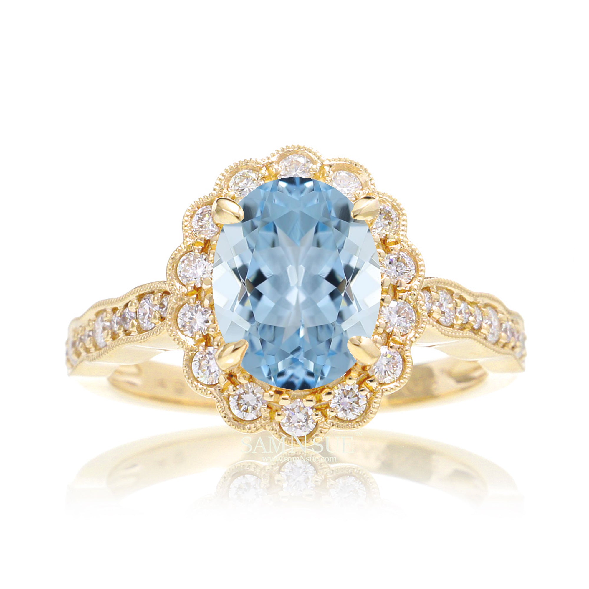 Oval aquamarine ring with diamond scallop halo and vintage diamond band in yellow gold