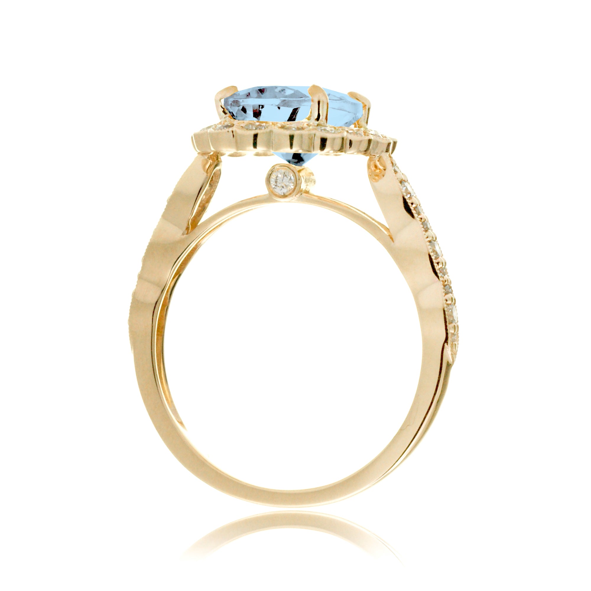 Oval aquamarine ring with diamond scallop halo and vintage diamond band in yellow gold