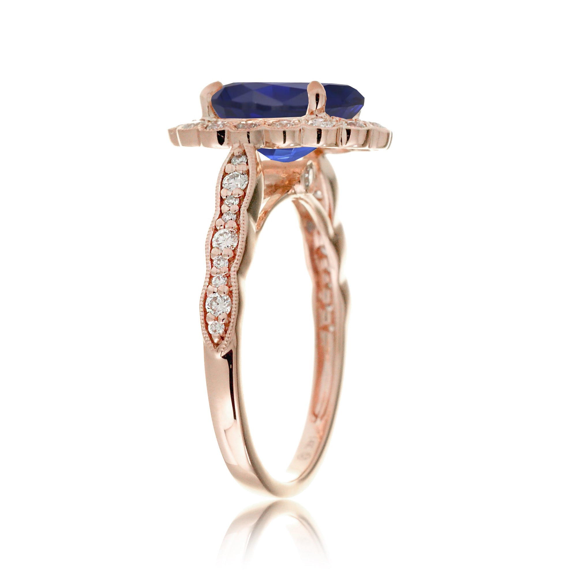Blue oval sapphire ring with diamond halo in a vintage scallop design rose gold