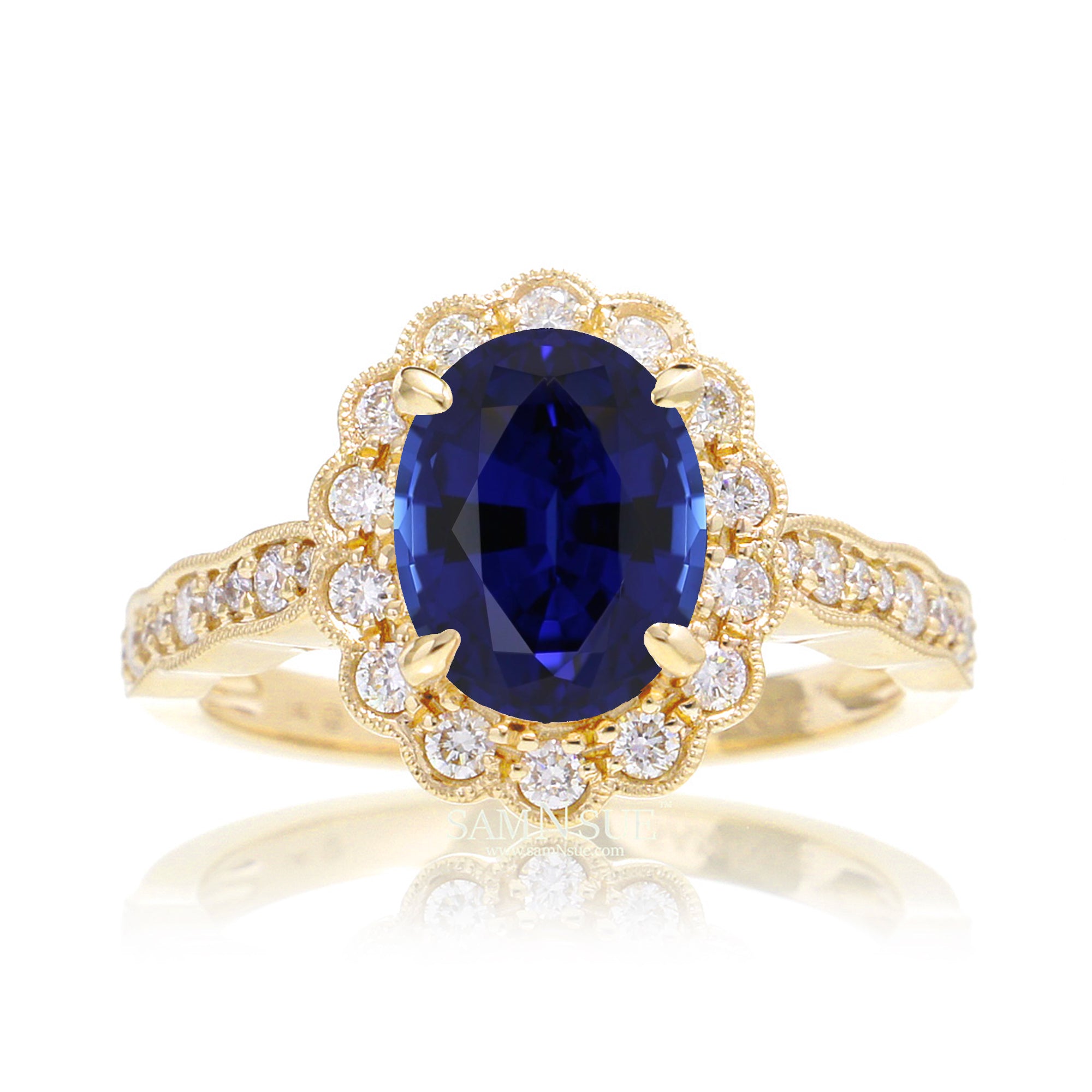 Blue oval sapphire ring with diamond halo in a vintage scallop design yellow gold