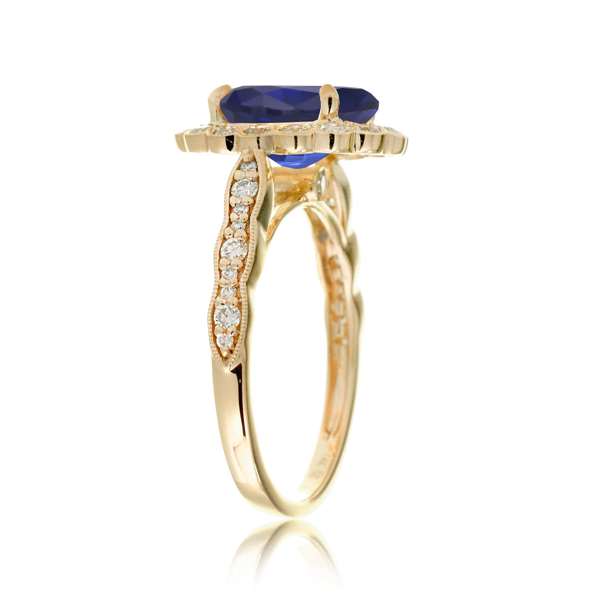 Blue oval sapphire ring with diamond halo in a vintage scallop design yellow gold